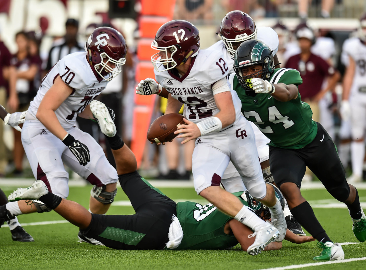 Katy, Tx. Sept. 28, 2019: Mayde Creek's Trejuan Holmes (24) gets the sack on Cinco Ranch's QB Clayton Keeling (12)during a conference game between Cinco Ranch and Mayde Creek at Legacy Stadium. (Photo by Mark Goodman / Katy Times)