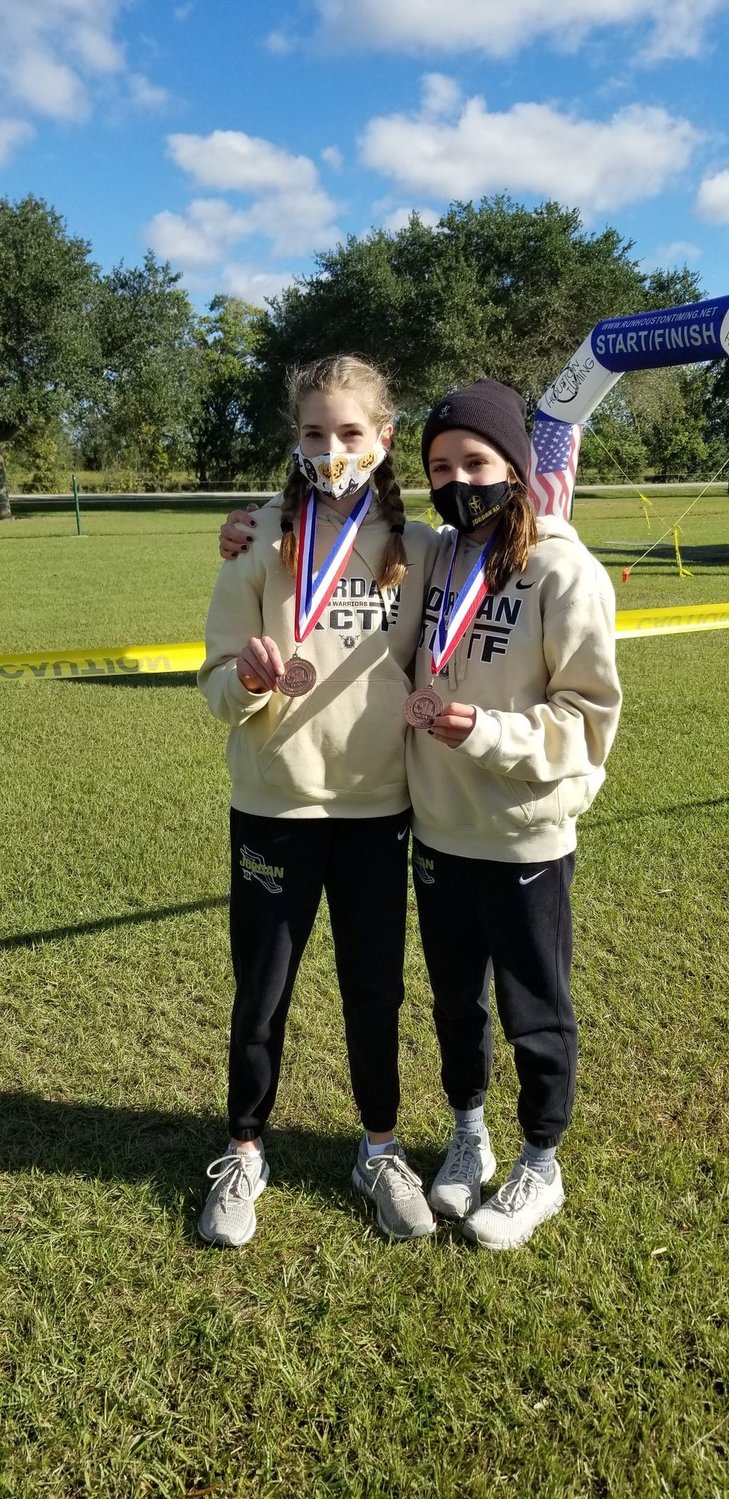 Jordan High freshmen Addison Sutton, left, and Beatriz Laepple qualified for regionals after finishing fifth and 10th, respectively, at the District 19-5A cross country championships Thursday morning in Katy.