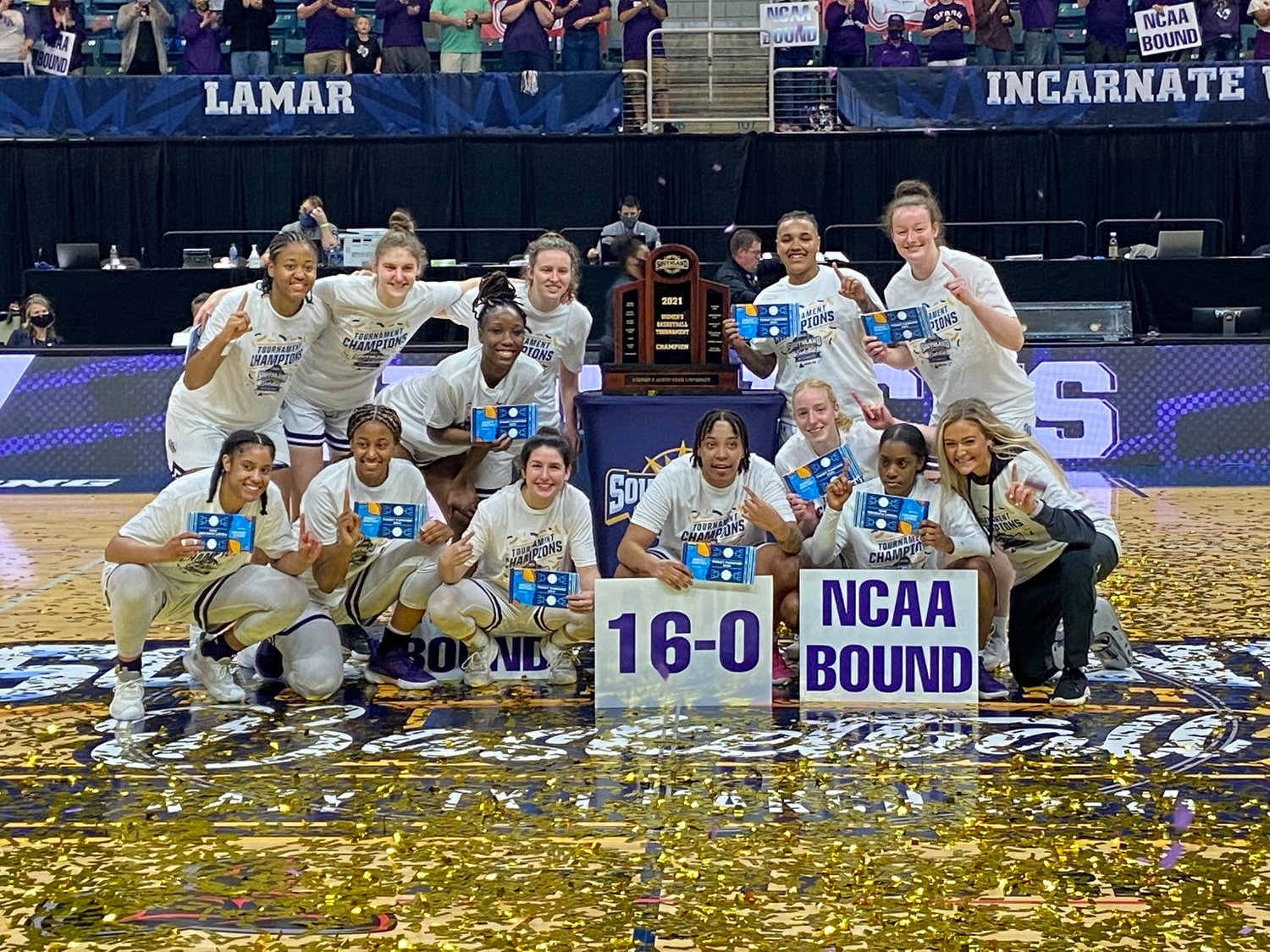 Stephen F. Austin players and coaches celebrate after the Ladyjacks beat Sam Houston State, 56-45, in the Southland Conference Tournament women's basketball championship game Sunday, March 14, at the Merrell Center.