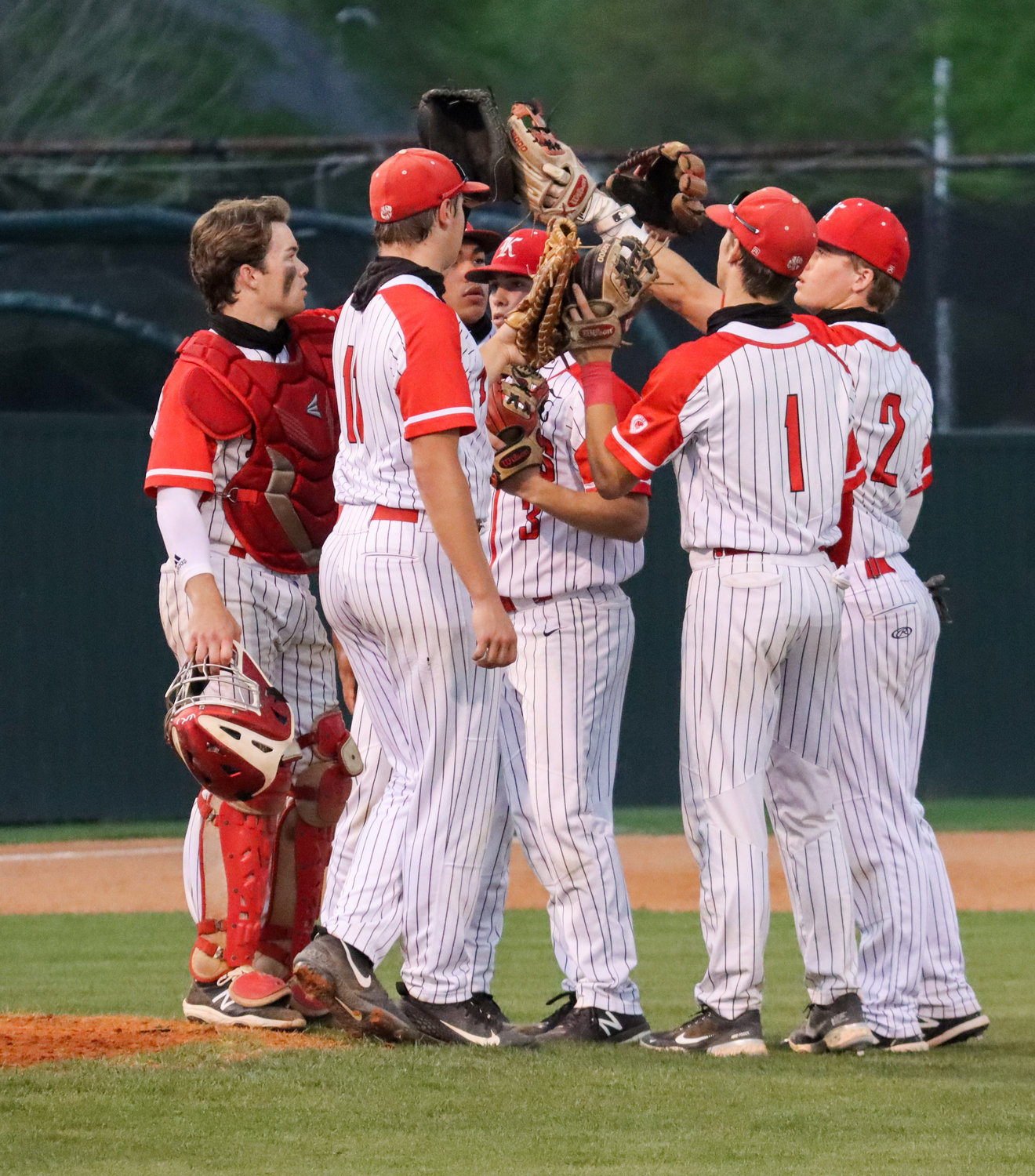 Katy players talk during a break in play during a game against Tompkins on Tuesday, March 30, at Katy High.