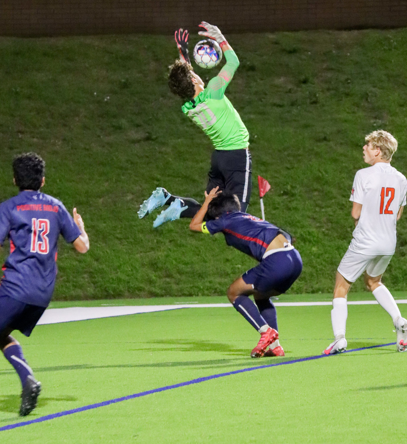 Tompkins senior goalkeeper Paulo Valente goes up for a save during the Falcons’ Class 6A regional quarterfinal win over Seven Lakes on Friday, April 2, at Rhodes Stadium.