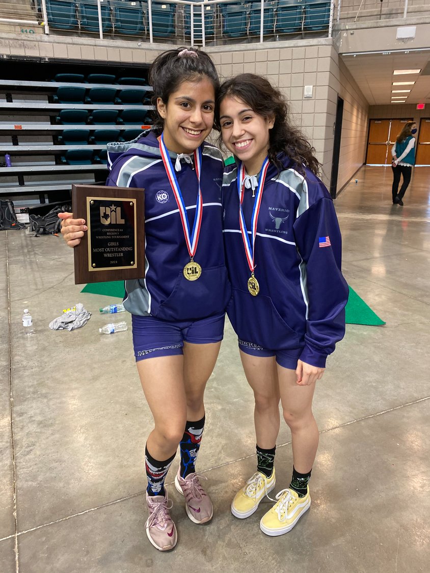Morton Ranch sisters Brittany and Rachel Cotter pose for a photo Saturday, April 17, after they won their respective weight class divisions at the Class 6A Region III wrestling meet at the Merrell Center.