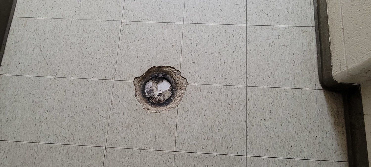 A variety of plumbing infrastructure issues are present in the Royal STEM Academy. Additionally, issues such as this drain create tripping hazards for students, teachers and other campus staff.