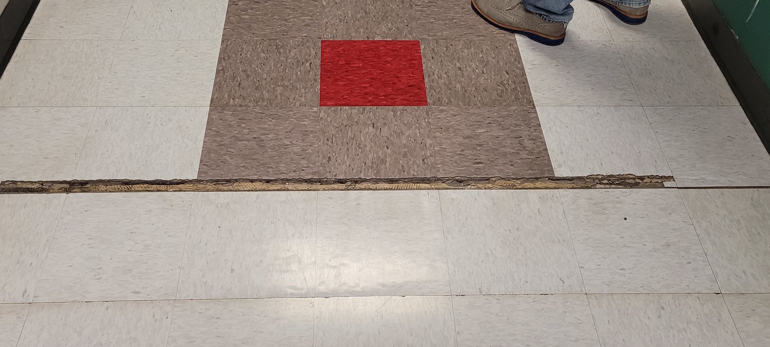 This crack in the floor at Royal Elementary School was caused by settling of the school's foundation over time. Operations staff said they would like to repair the floor and replace the tiling to remove tripping hazards from the school.