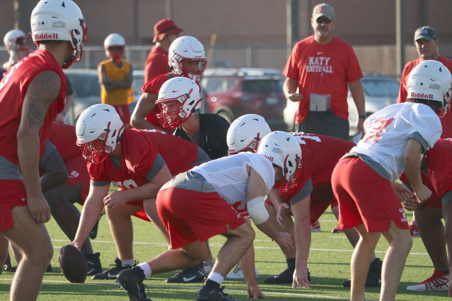 Katy High's offense lines up to run a play during Monday's practice at Tiger Stadium.