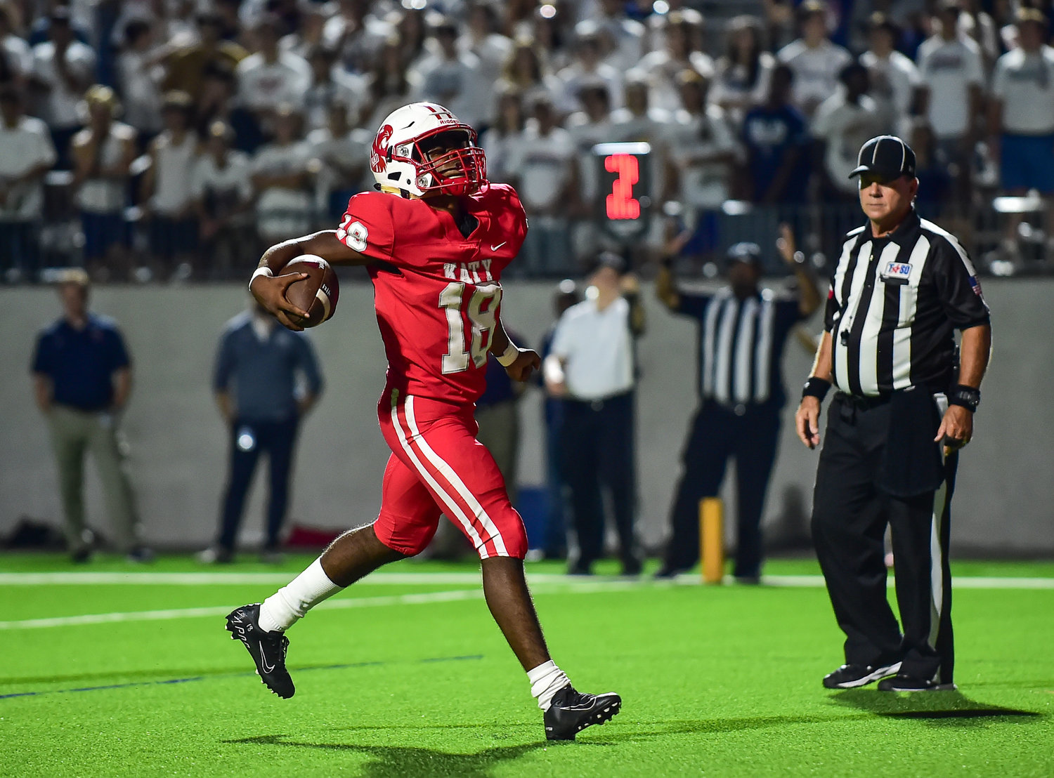 Katy, Tx. Oct. 1, 2021: Katy's #18 Dallas Glass carries the ball scoring a TD during a game between Katy Tigers and Tompkins Falcons at Legacy Stadium in Katy. (Photo by Mark Goodman / Katy Times)