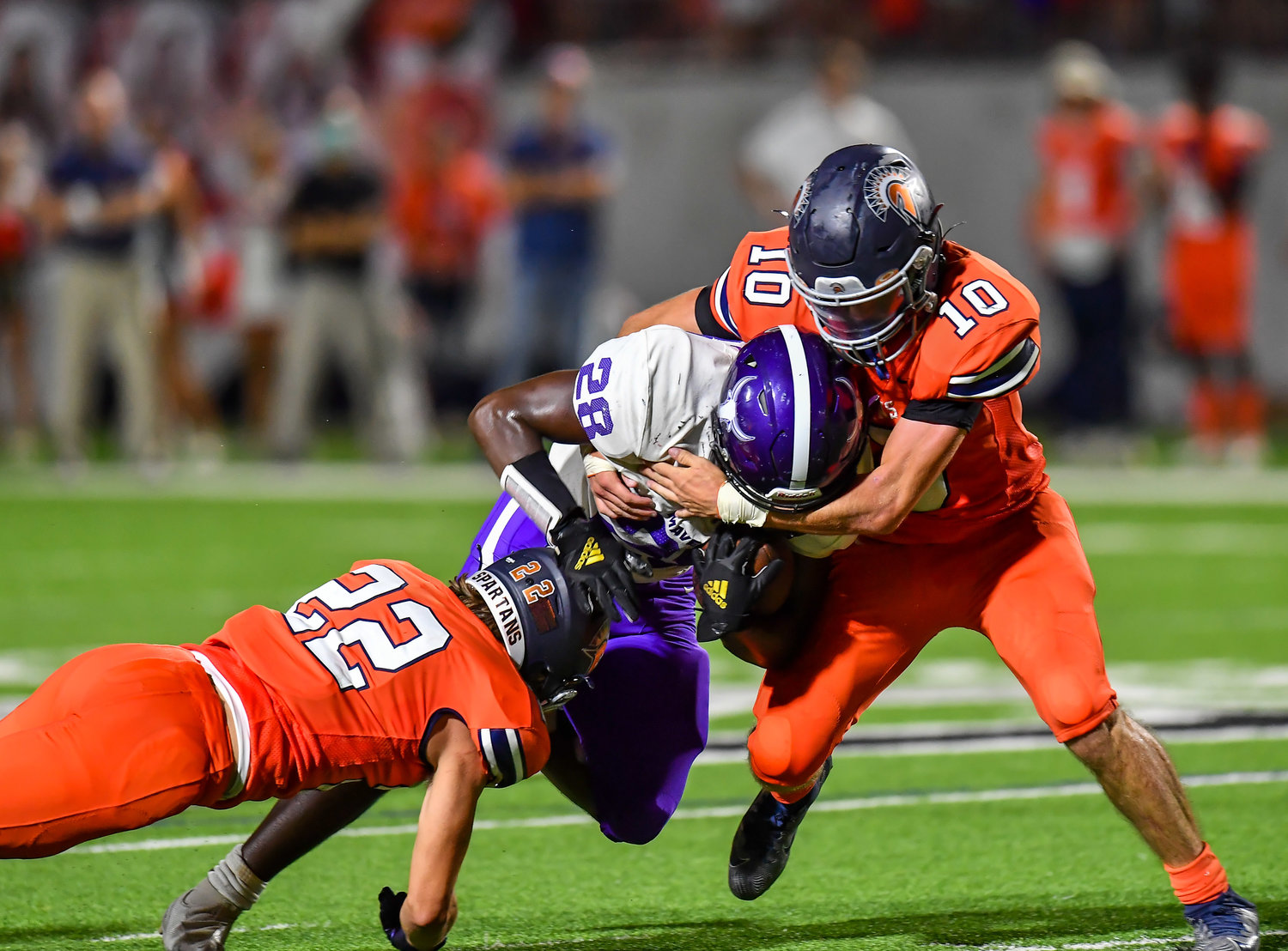 Katy, Tx. Oct. 8, 2021: Seven Lakes Scott Stanford #10 and Seven Lakes Bryce Turner #22 make the stop on Morton Ranch Ryan Hall #28 during a District 19-6A game between Seven Lakes and Morton Ranch at Legacy Stadium in Katy. (Photo by Mark Goodman / Katy Times)