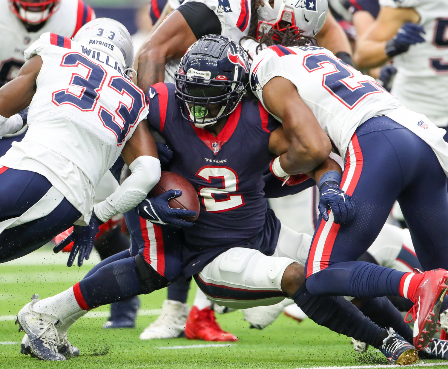 Houston Texans running back Mark Ingram (2) is bottled up on a carry during an NFL game between Houston and New England on October 10, 2021 in Houston, Texas. The Patriots won 25-22.