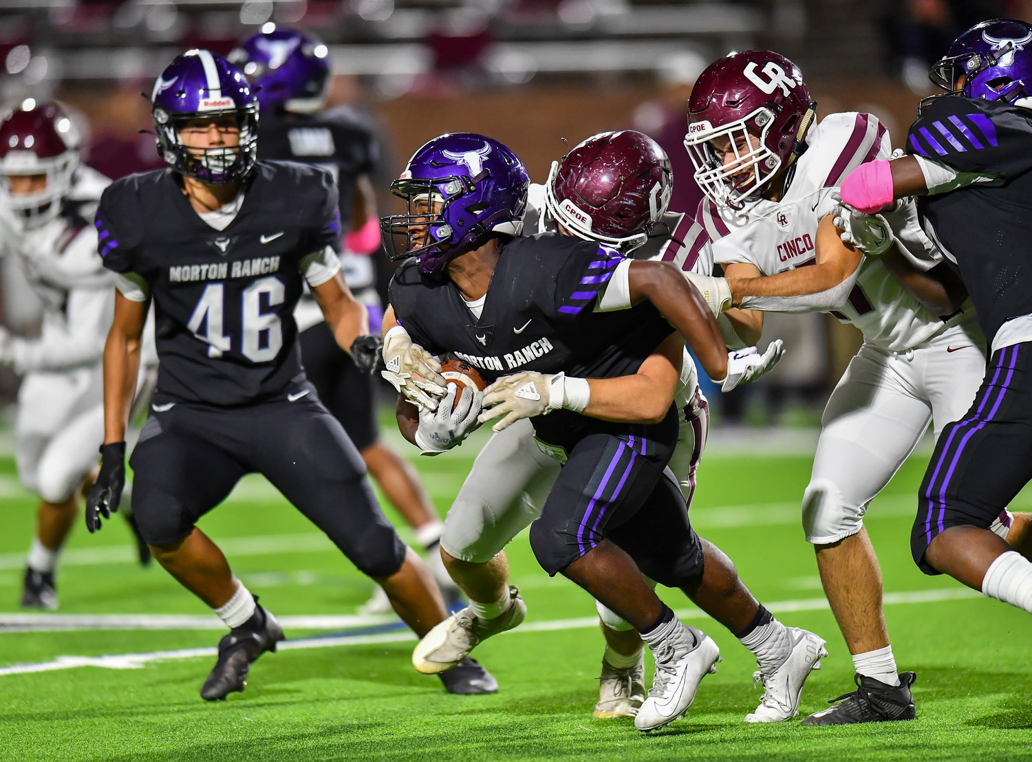 Katy, Tx. Oct 29, 2021: Morton Ranch Santana Scott #3 carries the ball up the middle before being brought down by Cougar defenders during a conference game between Cinco Ranch and Morton Ranch at Rhodes Stadium in Katy. (Photo by Mark Goodman / Katy Times)