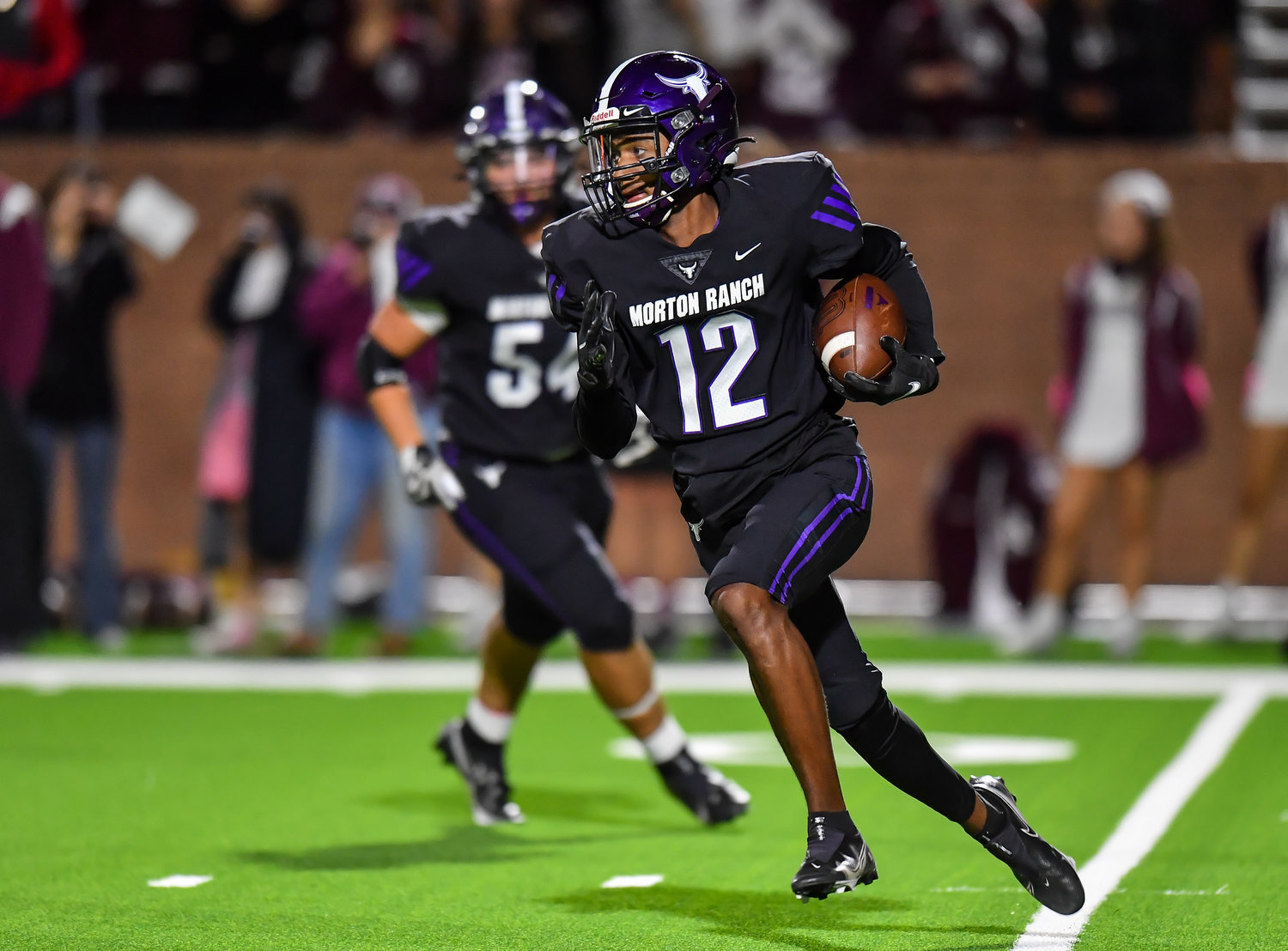 Katy, Tx. Oct 29, 2021: Morton Ranch's Mike Gerald #12 carries the ball during a conference game between Cinco Ranch and Morton Ranch at Rhodes Stadium in Katy. (Photo by Mark Goodman / Katy Times)