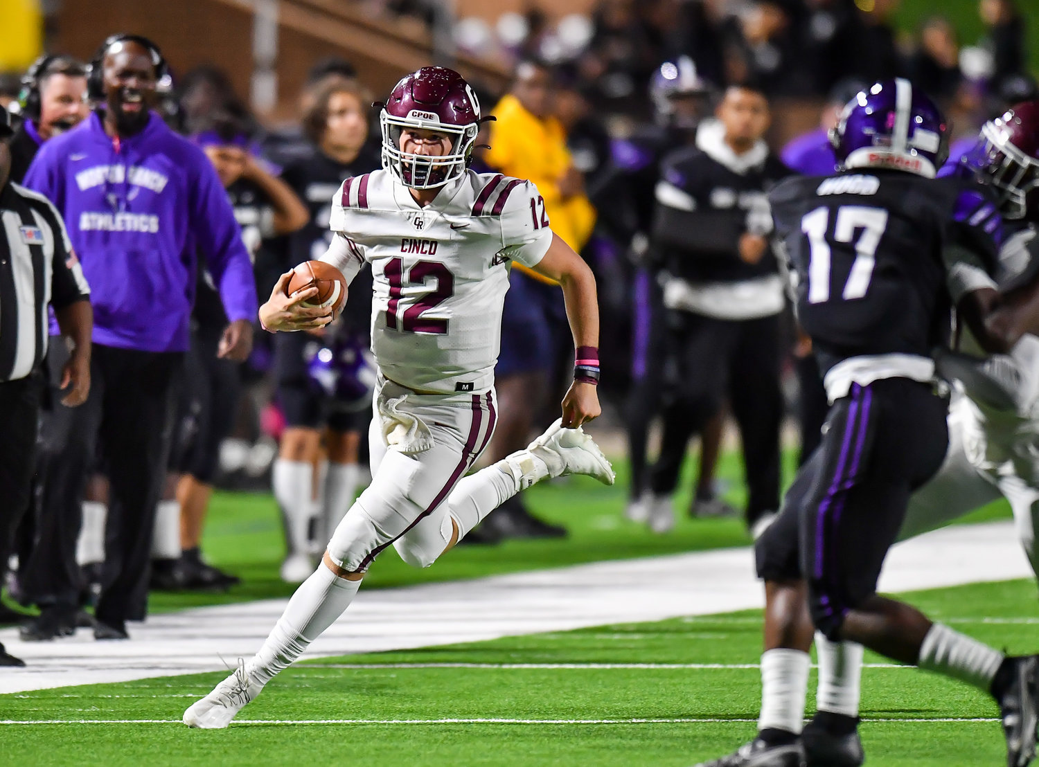 Katy, Tx. Oct 29, 2021: Cinco Ranch's QB Gavin Rutherford #12 carries the ball before being pushed out of bounds during a conference game between Cinco Ranch and Morton Ranch at Rhodes Stadium in Katy. (Photo by Mark Goodman / Katy Times)