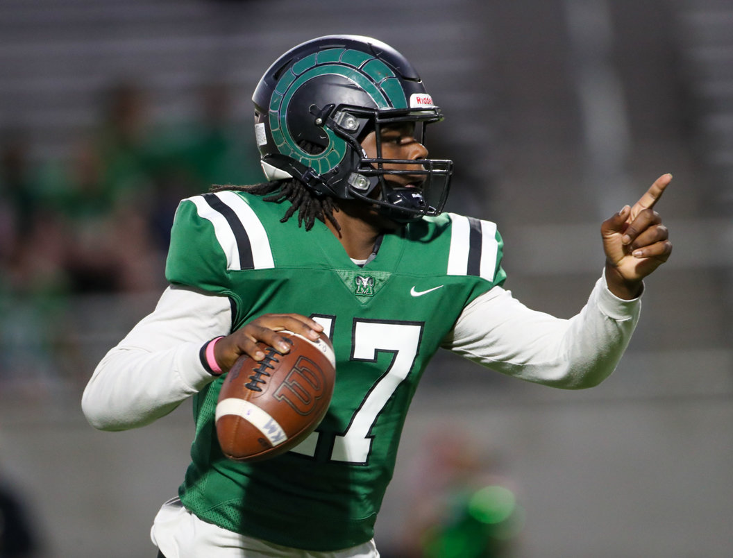 Mayde Creek Rams quarterback Carldell Beard (17) rolls out looking to pass and gestures to a receiver downfield during a high school football game between Mayde Creek and Seven Lakes on October 29, 2021 in Katy, Texas. Seven Lakes won, 50-10.