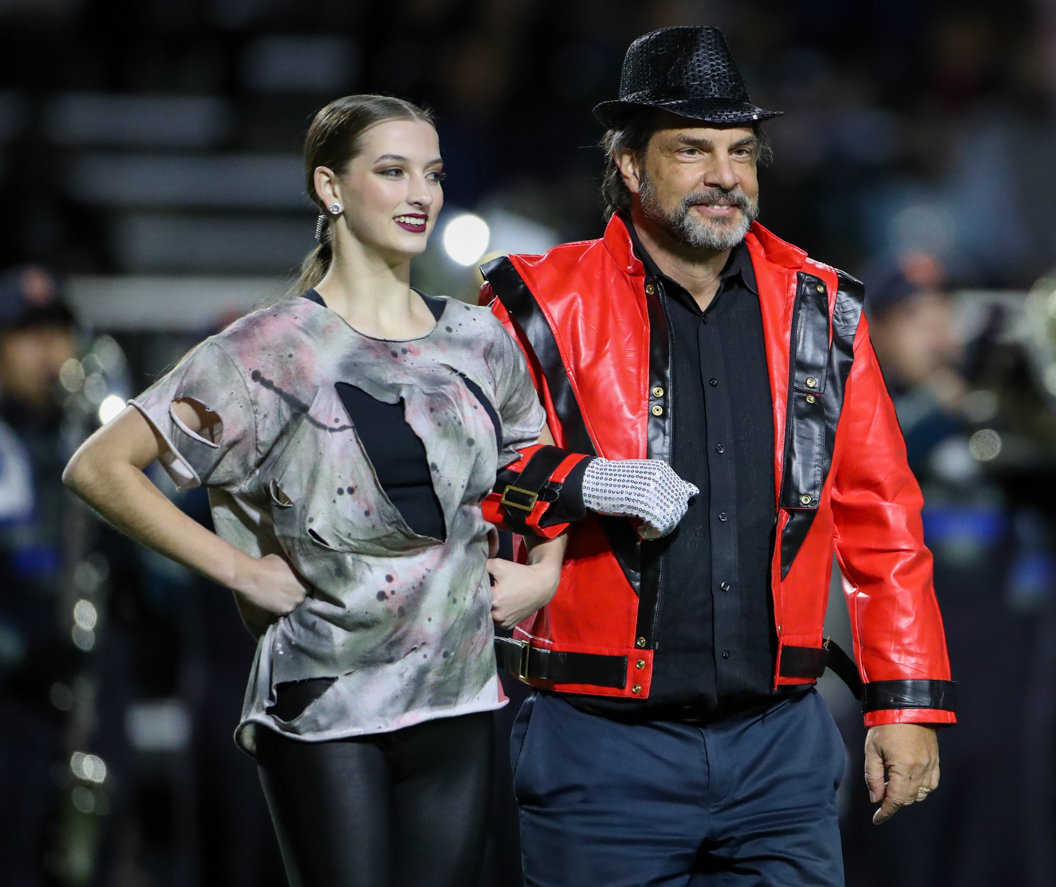 Parents and members of the Seven Lakes Spartans dance team perform a Halloween-themed halftime show during a high school football game between Mayde Creek and Seven Lakes on October 29, 2021 in Katy, Texas. Seven Lakes won, 50-10.