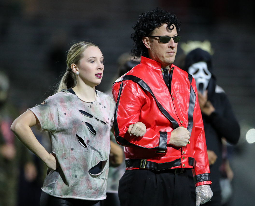 Parents and members of the Seven Lakes Spartans dance team perform a Halloween-themed halftime show during a high school football game between Mayde Creek and Seven Lakes on October 29, 2021 in Katy, Texas. Seven Lakes won, 50-10.