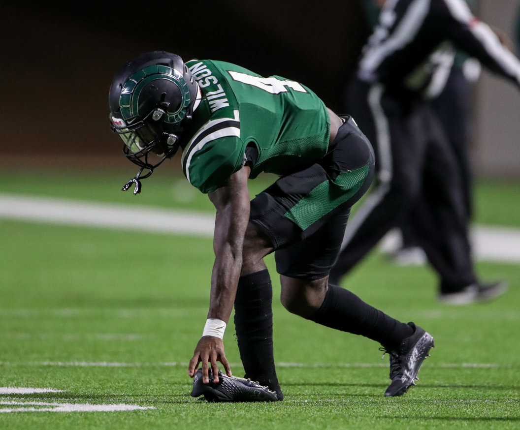 Mayde Creek Rams defensive back Tay'Shawn Wilson (4) picks up his shoe after a play in a high school football game between Mayde Creek and Seven Lakes on October 29, 2021 in Katy, Texas. Seven Lakes won, 50-10.