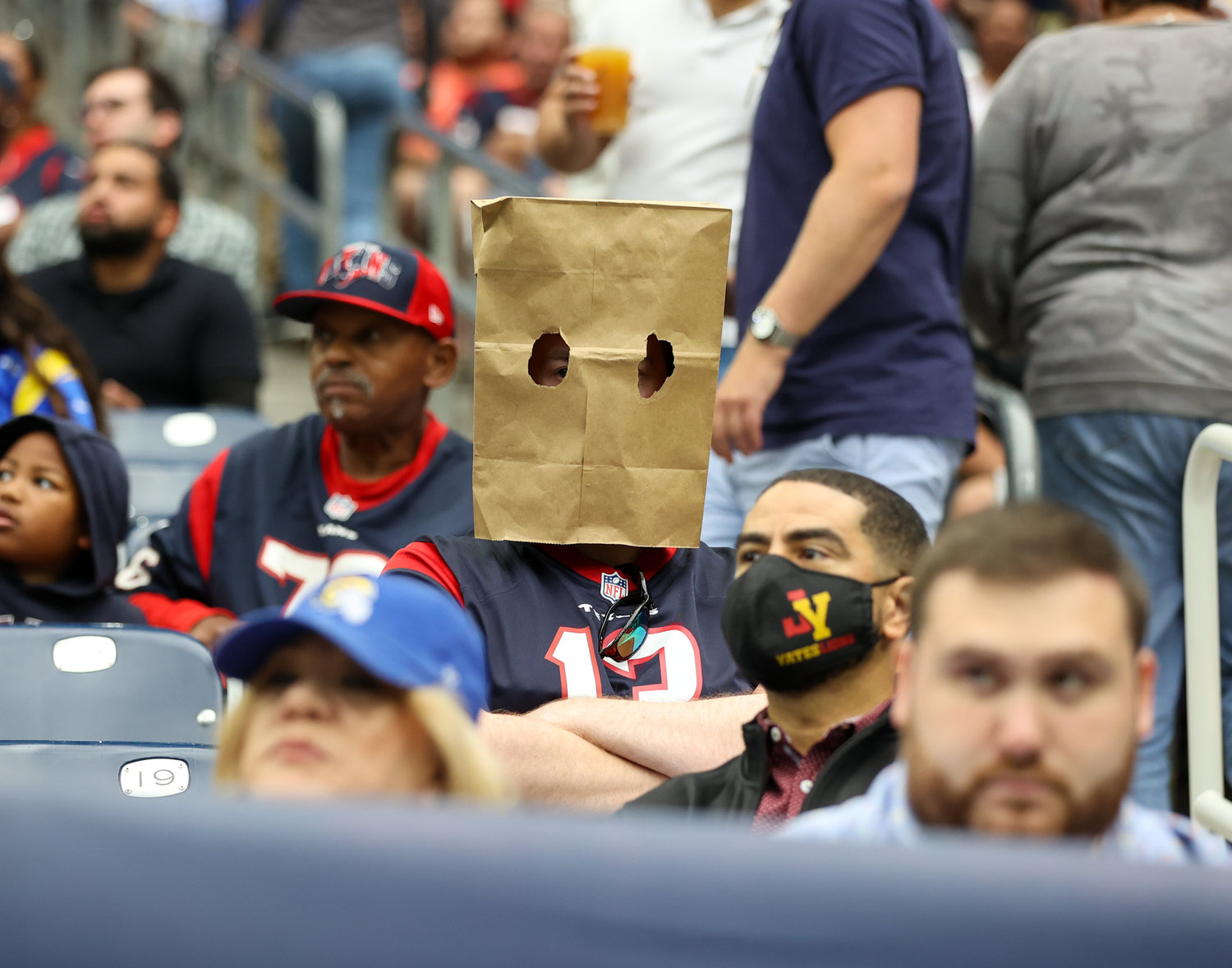 A Houston Texans fan wears a bag over his head on a Halloween day game during an NFL game between Houston and the Los Angeles Rams, October 31, 2021 in Houston, Texas.
