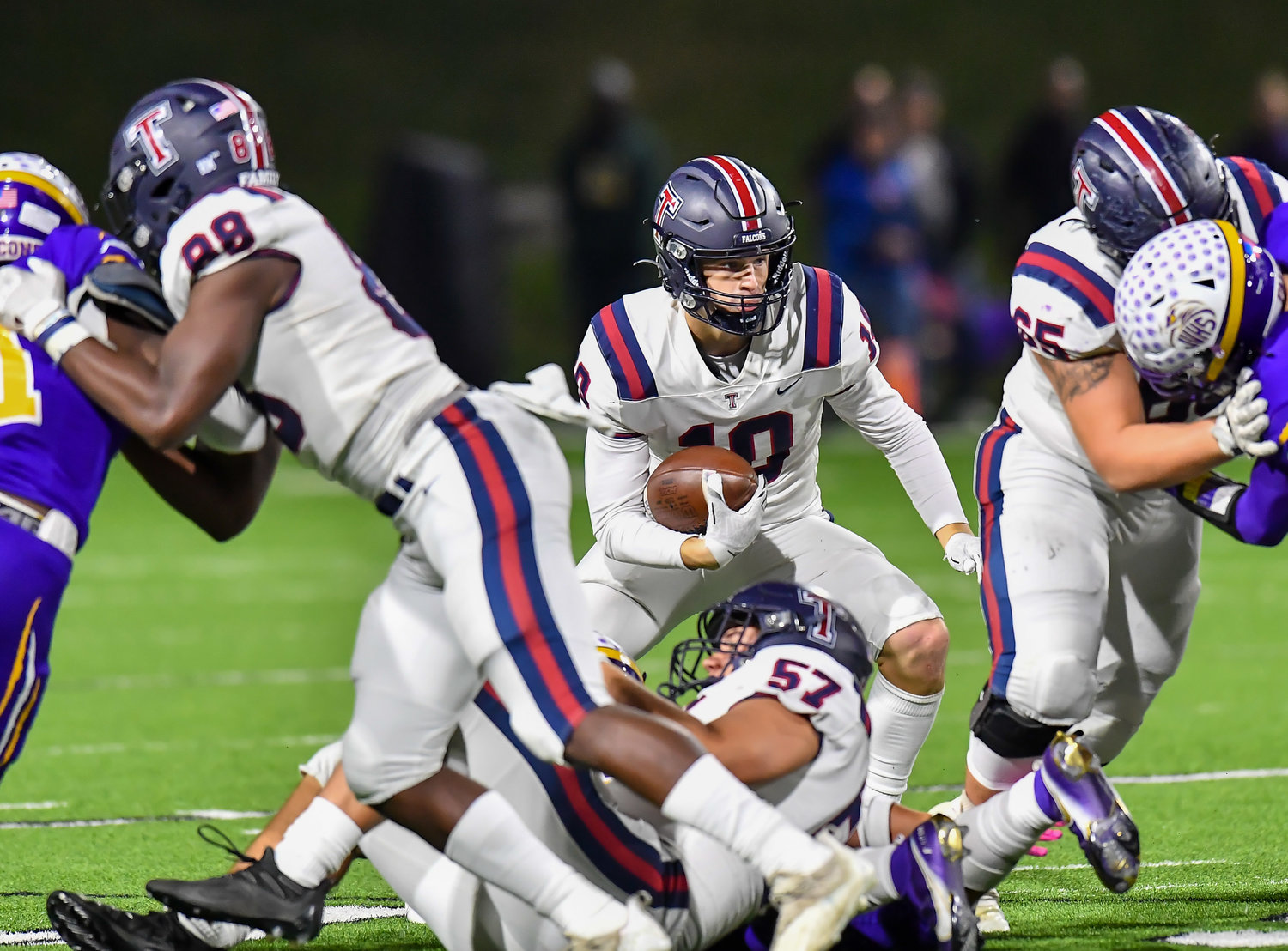 Houston Tx. Nov 19, 2021: Tompkins #10 Wyatt Young gets blocking help from #65 Ethan Vazquez as he carries the ball up the middle during the UIL area playoff game between Tompkins and Jersey Village at Pridgeon Stadium in Houston. (Photo by Mark Goodman / Katy Times)
