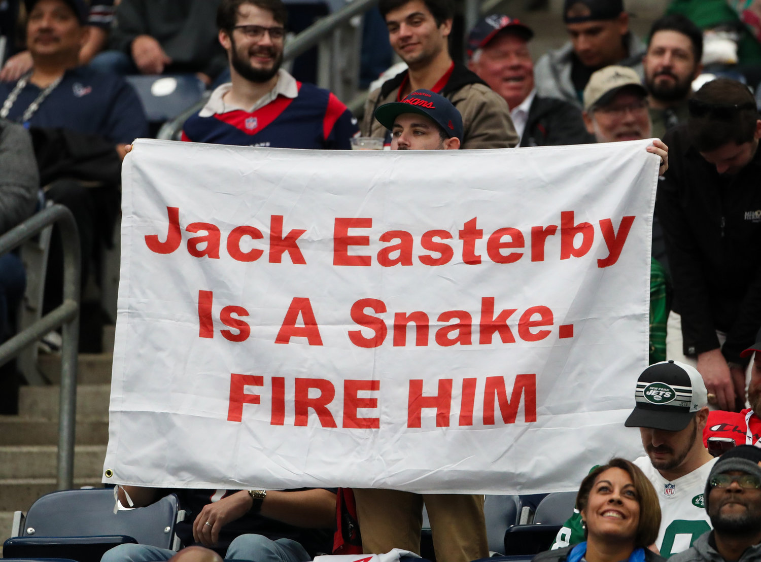A Houston Texans fan holds up a sign about controversial Texans Executive Vice President of Operations Jack Easterby during an NFL game between the Houston Texans and the New York Jets on November 28, 2021 in Houston, Texas. The Jets won, 21-14