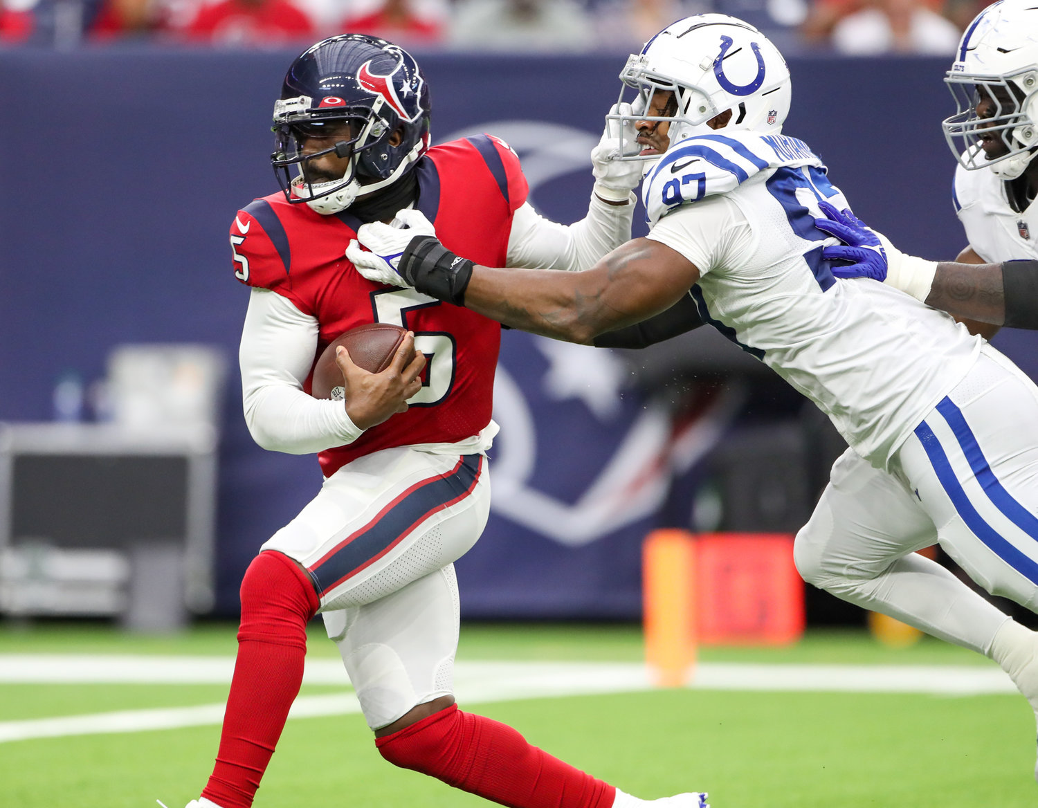 Indianapolis Colts defensive end Al-Quadin Muhammad (97) sacks Houston Texans quarterback Tyrod Taylor (5) during an NFL game between the Texans and the Colts on December 5, 2021 in Houston, Texas.