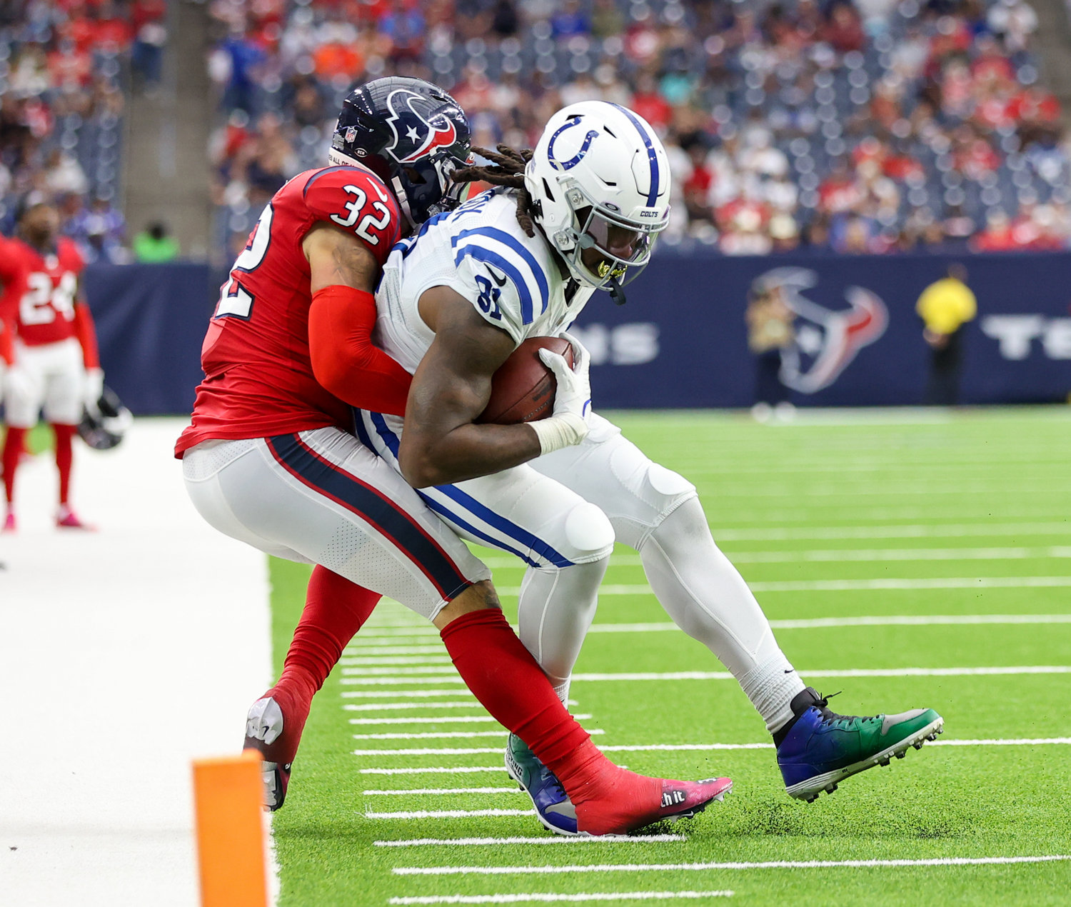 Houston Texans linebacker Garret Wallow (32) tackles Indianapolis Colts tight end Mo Alie-Cox (81) after a catch during an NFL game between the Texans and the Colts on December 5, 2021 in Houston, Texas. The Colts won, 31-0.