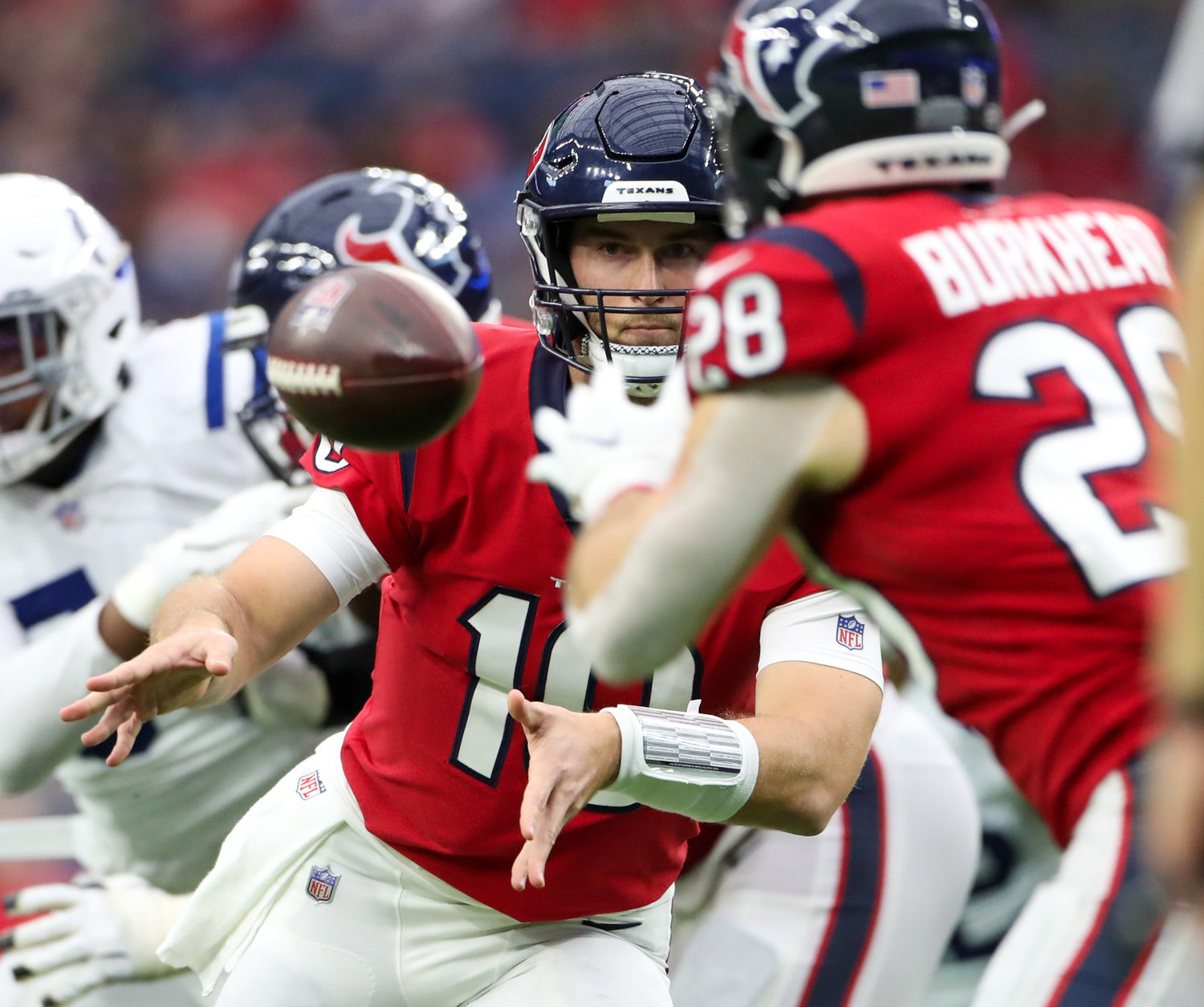 Houston Texans quarterback Davis Mills (10) pitches the ball to running back Rex Burkhead (28) during an NFL game between the Texans and the Colts on December 5, 2021 in Houston, Texas. The Colts won, 31-0.