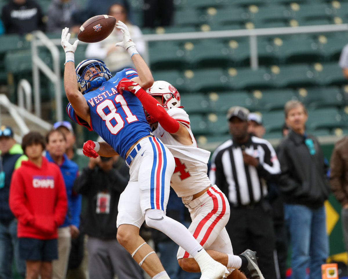 Westlake Chaparrals wide receiver Pierce Turner (81) brings in a touchdown pass over Katy Tigers defensive back Hamilton McMartin (24) during the Class 6A Division II state semifinal  game between Katy and Westlake on December 11, 2021 in Waco, Texas.