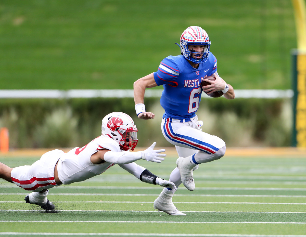 Westlake Chaparrals quarterback Cade Klubnik (6) escapes the grasp of Katy Tigers defensive back Arian Parish (6) on a carry during the Class 6A Division II state semifinal  game between Katy and Westlake on December 11, 2021 in Waco, Texas.