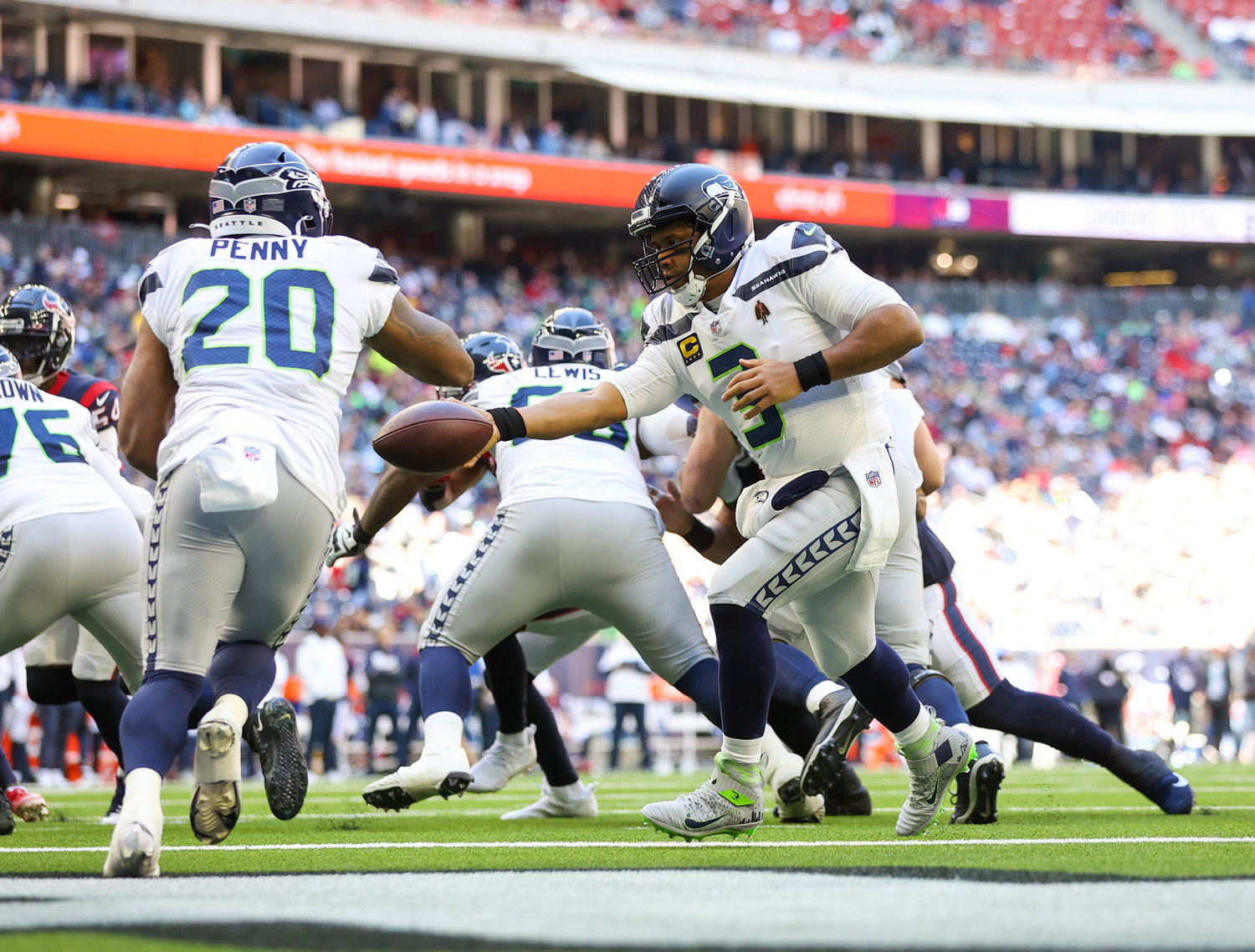 Seattle Seahawks quarterback Russell Wilson (3) hands the ball off to running back Rashaad Penny (20) in his own end zone during the first half of an NFL game between the Seahawks and the Texans on December 12, 2021 in Houston, Texas.