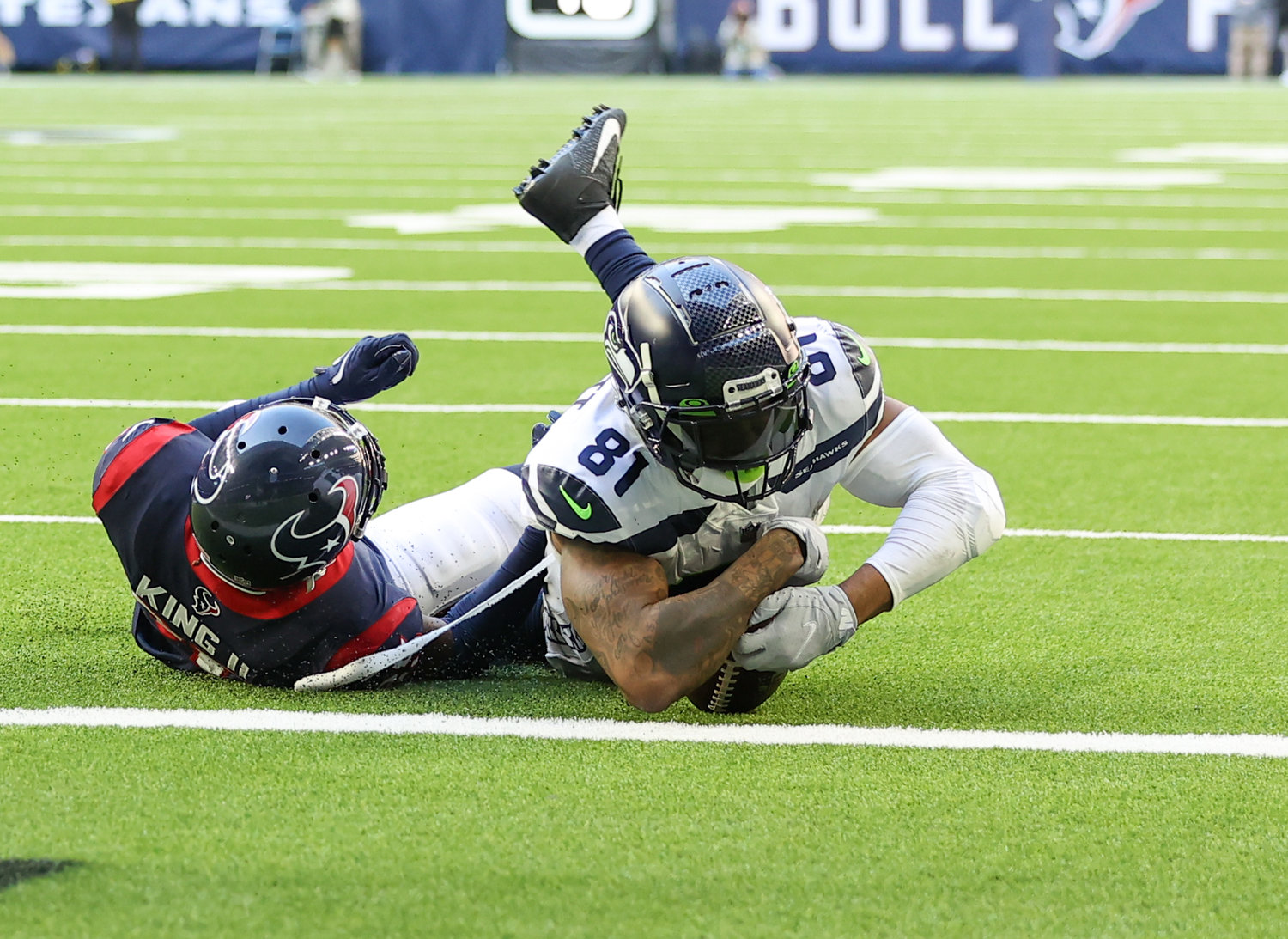 Seattle Seahawks tight end Gerald Everett (81) is tackled by Houston Texans cornerback Desmond King II (25) on a play that was ruled a Seattle touchdown during the second half of an NFL game between the Seahawks and the Texans on December 12, 2021 in Houston, Texas.