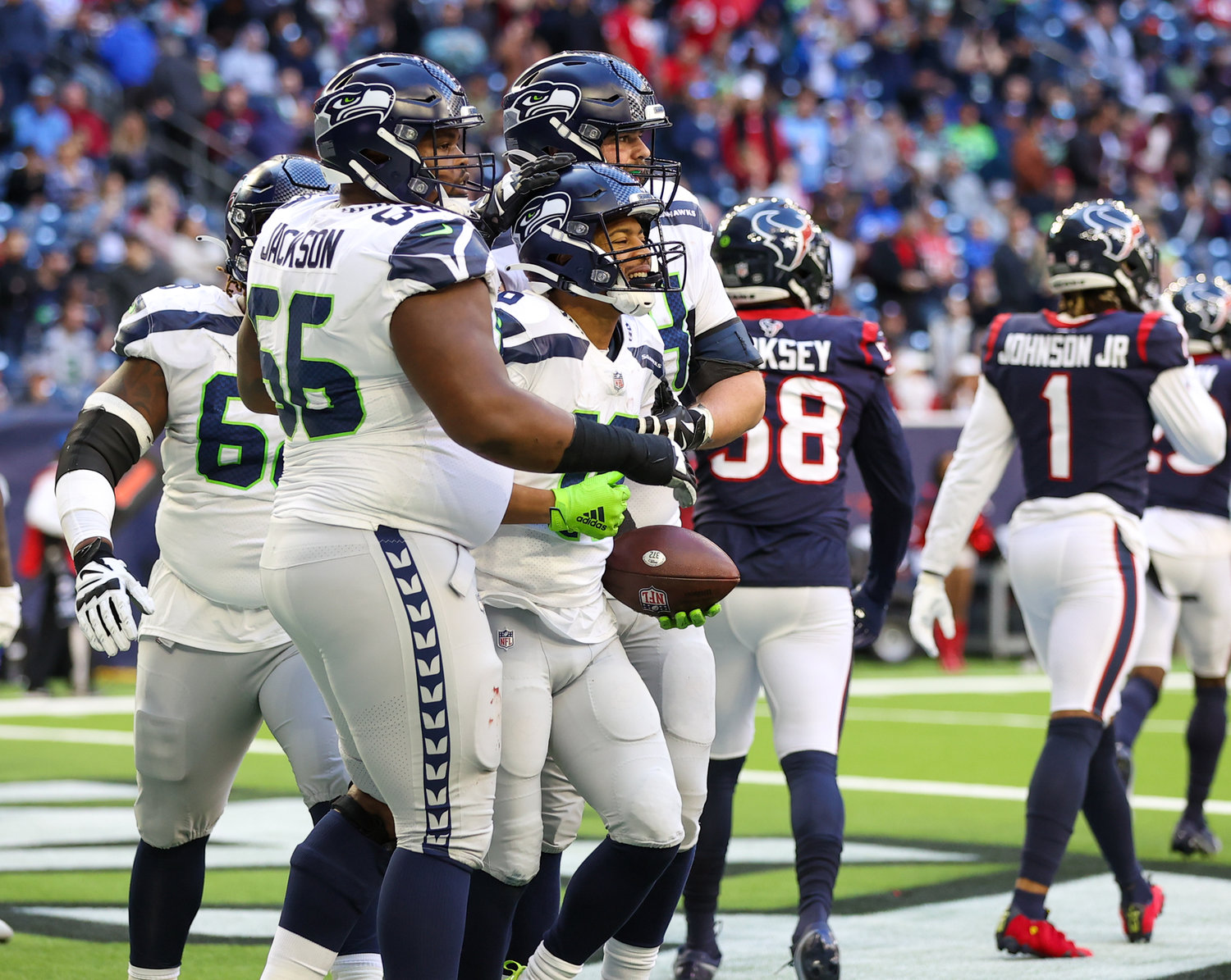 Teammates congratulate Seattle Seahawks wide receiver Tyler Lockett (16) after a two-point conversion during the second half of an NFL game between the Seahawks and the Texans on December 12, 2021 in Houston, Texas.