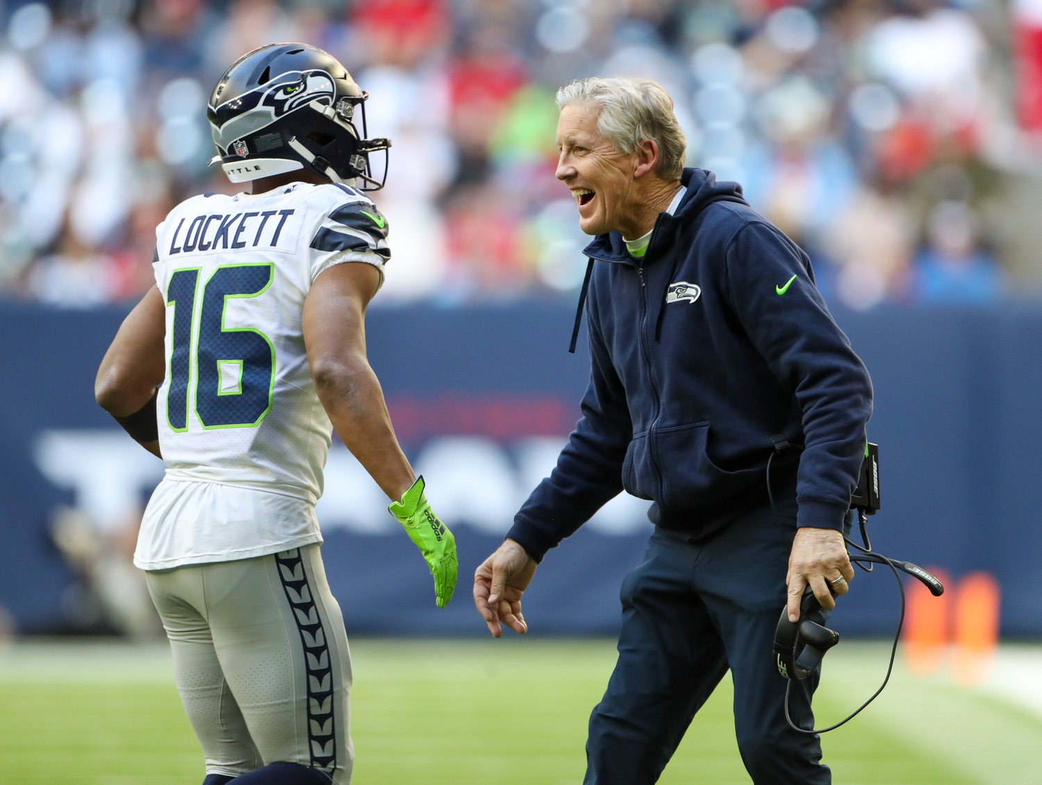 Seattle Seahawks head coach Pete Carroll congratulates wide receiver Tyler Lockett (16) after a successful two-point conversion during the second half of an NFL game between the Seahawks and the Texans on December 12, 2021 in Houston, Texas.