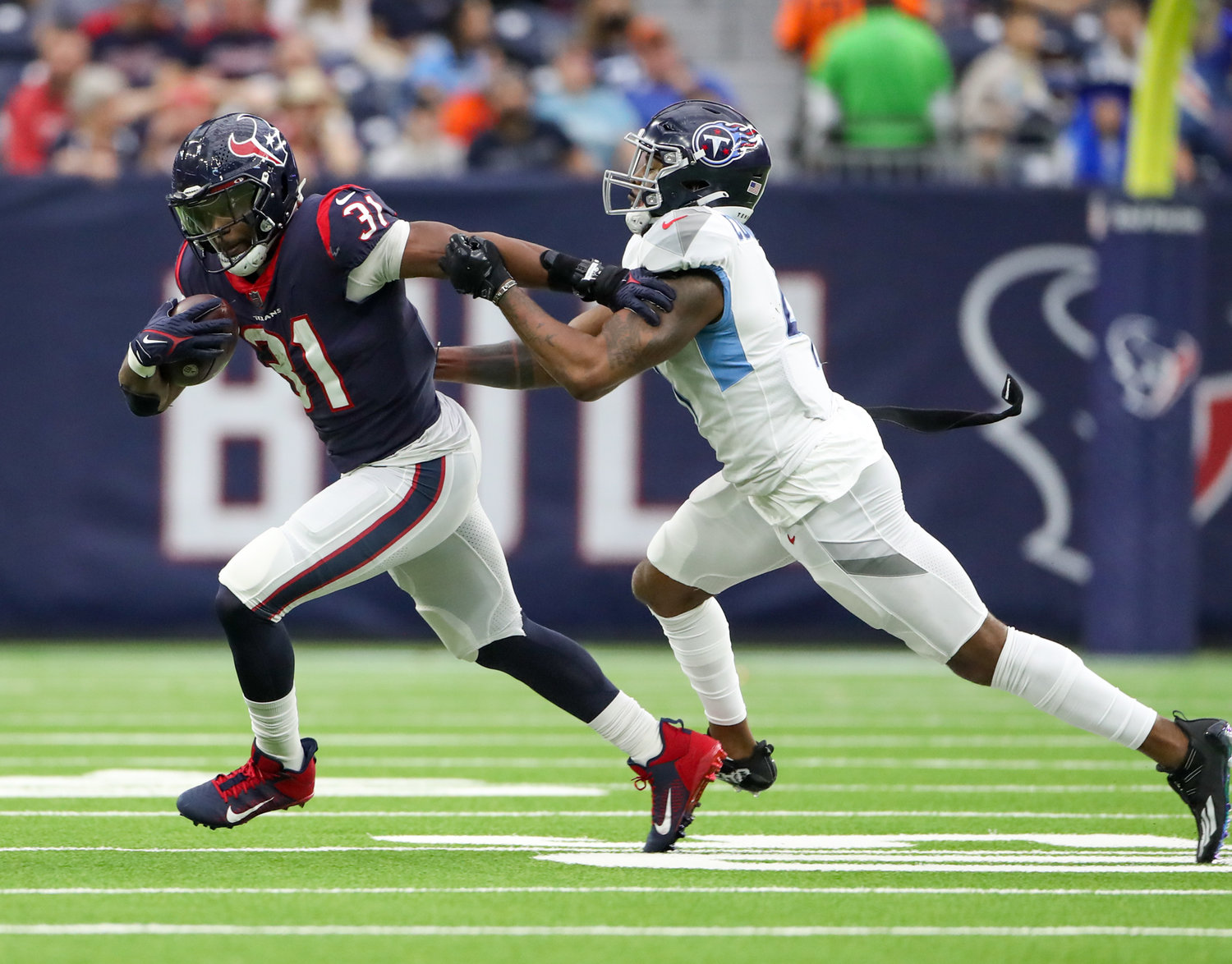Houston Texans running back David Johnson (31) works to elude Tennessee Titans outside linebacker Zach Cunningham (41) during an NFL game on Jan. 9, 2022 in Houston, Texas. The Titans won, 28-25.