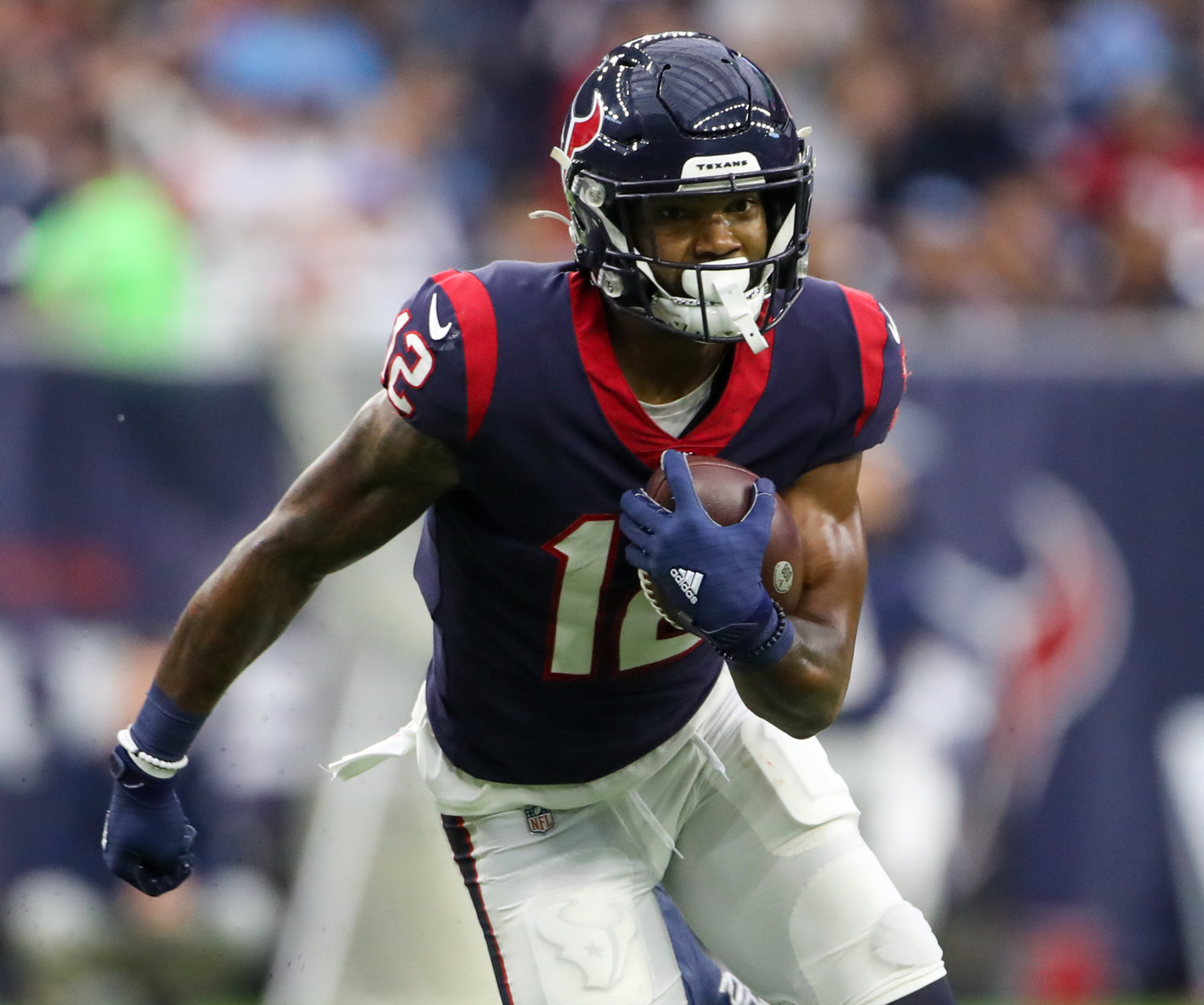 Houston Texans wide receiver Nico Collins (12) carries the ball after a catch during an NFL game between the Texans and the Titans on Jan. 9, 2022 in Houston, Texas. The Titans won, 28-25.