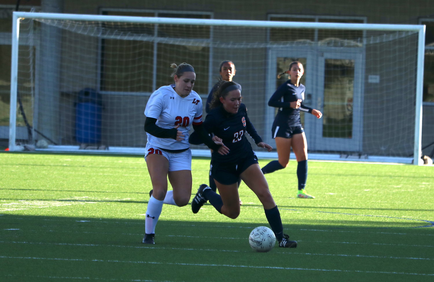Laura Davis battles to gain possession of the ball during Saturday’s game between Seven Lakes and Lake Travis at Legacy Stadium.