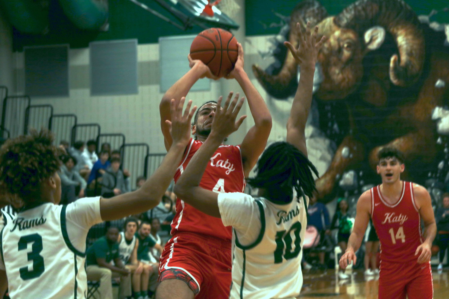 Katy’s Dayvaughn Froe shoots a fadeaway over two Mayde Creek defenders during Wednesday’s game at the Mayde Creek gym.