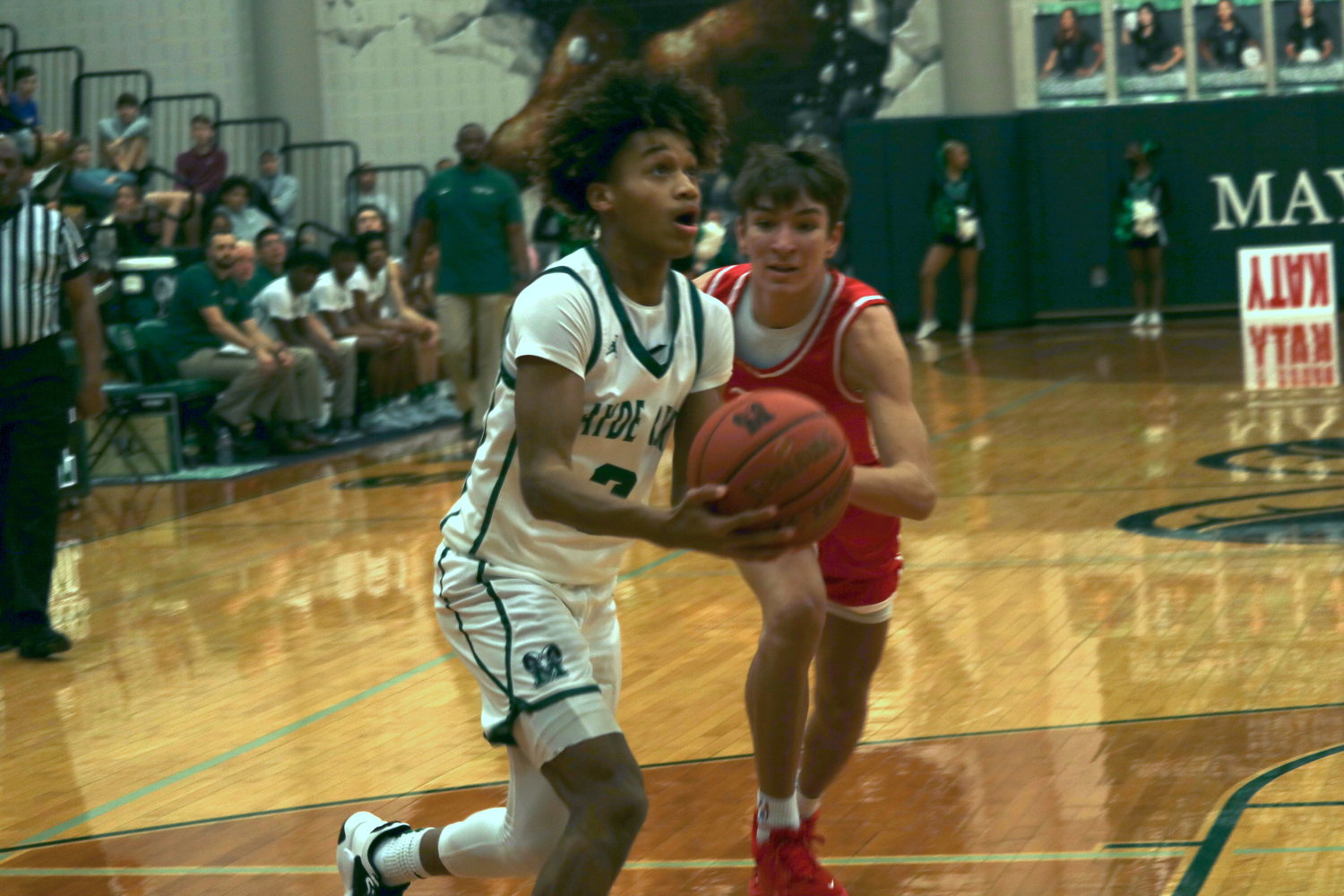 Mayde Creek’s Christian Jones shoots a layup defend during Wednesday’s game at the Mayde Creek gym.