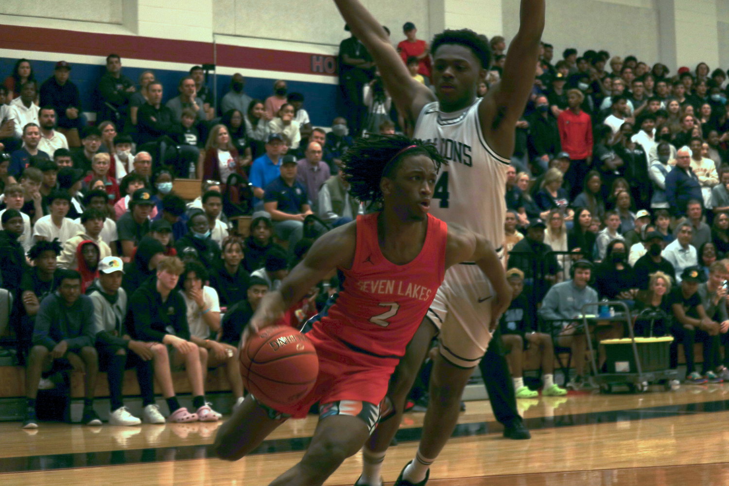 Seven Lakes’ Tahaad Davis drives past Tompkins’ Carmelo Yakubu during Wednesday’s game at the Tompkins gym.