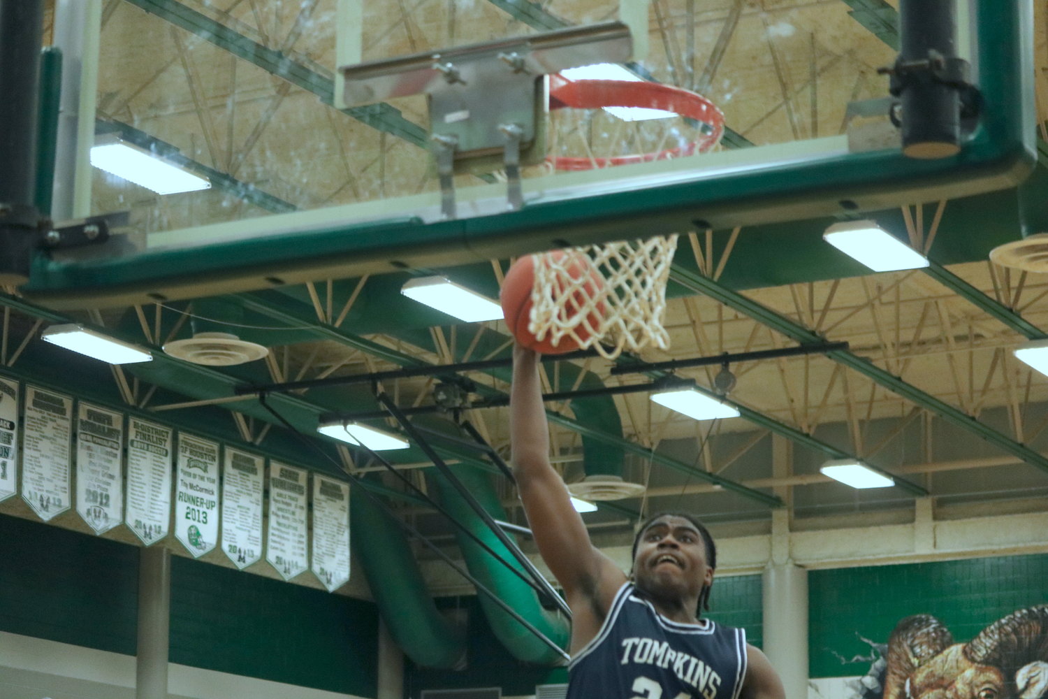 Jason Clark dunks during Wednesday’s game between Mayde Creek and Tompkins at the Mayde Creek gym.