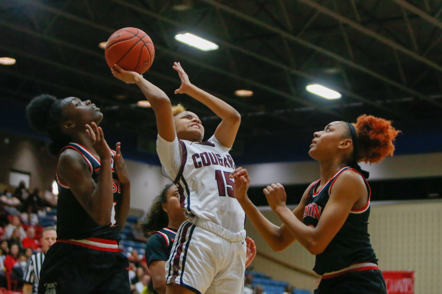 Daniele Williams shoots over defenders during Tuesday's game between Cinco Ranch and Fort Bend Autin.