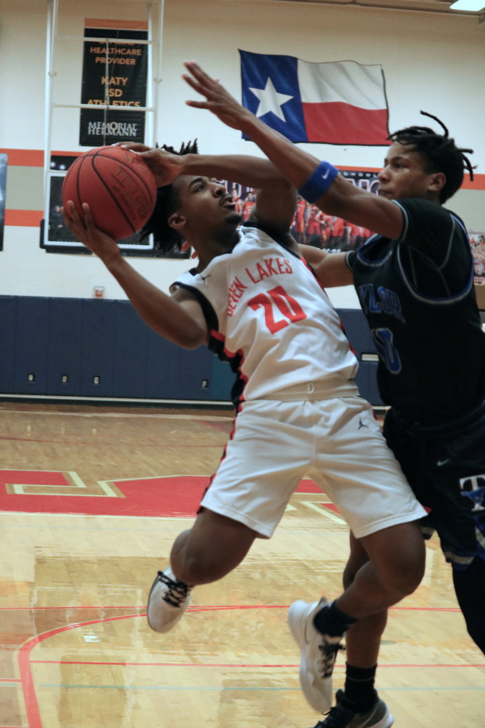 Steve Bluiett shoots over a defender during Wednesday’s game between Seven Lakes and Taylor at the Seven Lakes gym.