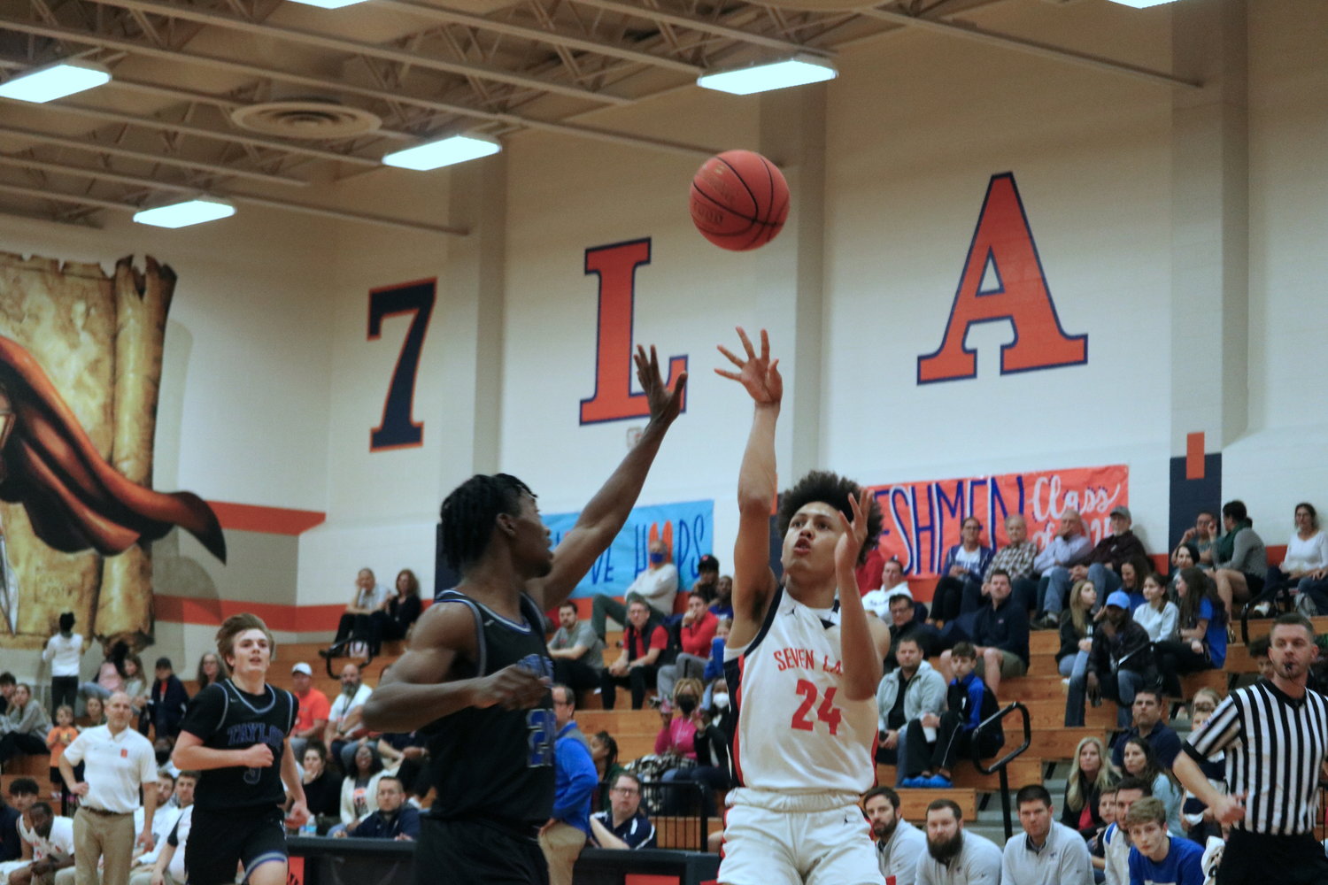 AJ Bates throws a lob pass during Wednesday’s game between Seven Lakes and Taylor at the Seven Lakes gym.