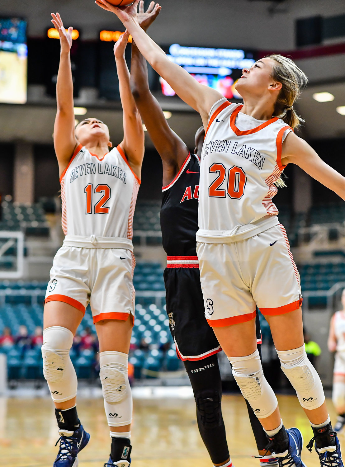 Katy Tx. Feb 22, 2022:  Seven Lakes Summer Halphen #20, Seven Lakes Cailyn Tucker #12 and a Fort Bend Austins player battle for the rebound during the Regional Quarterfinal playoff game, Seven Lakes vs Fort Bend Austin at the Merrell Center. (Photo by Mark Goodman / Katy Times)