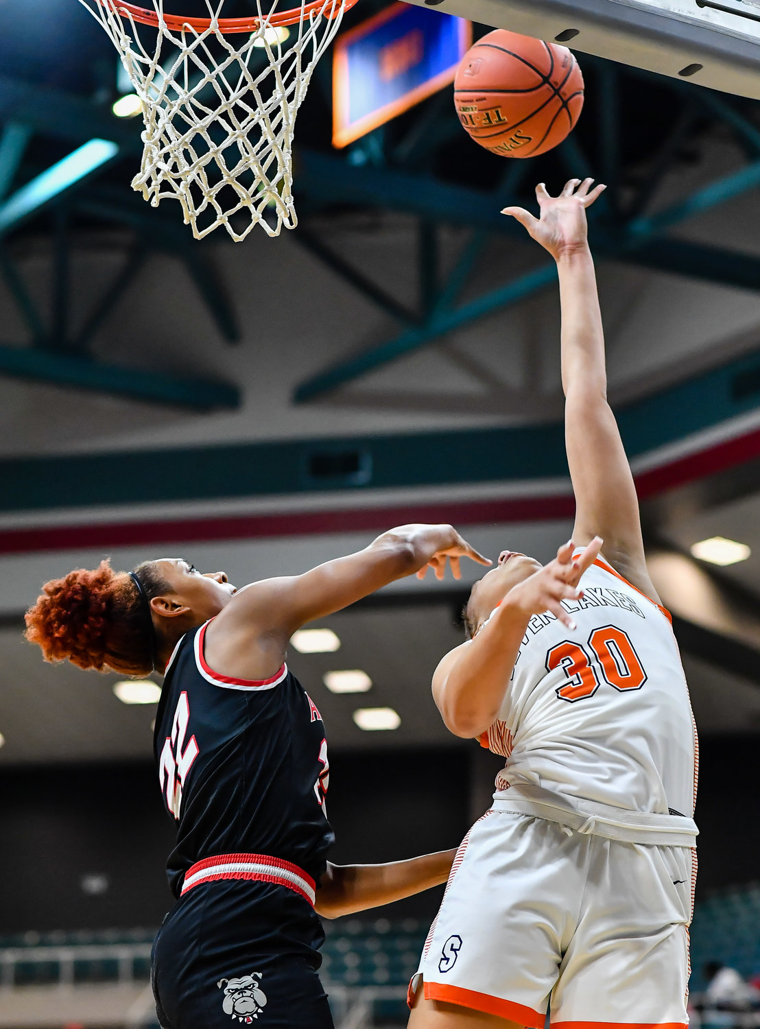 Katy Tx. Feb 22, 2022:   Seven Lakes Justice Carlton #30 get the shot off scoring for the Spartans during the Regional Quarterfinal playoff game, Seven Lakes vs Fort Bend Austin at the Merrell Center. (Photo by Mark Goodman / Katy Times)