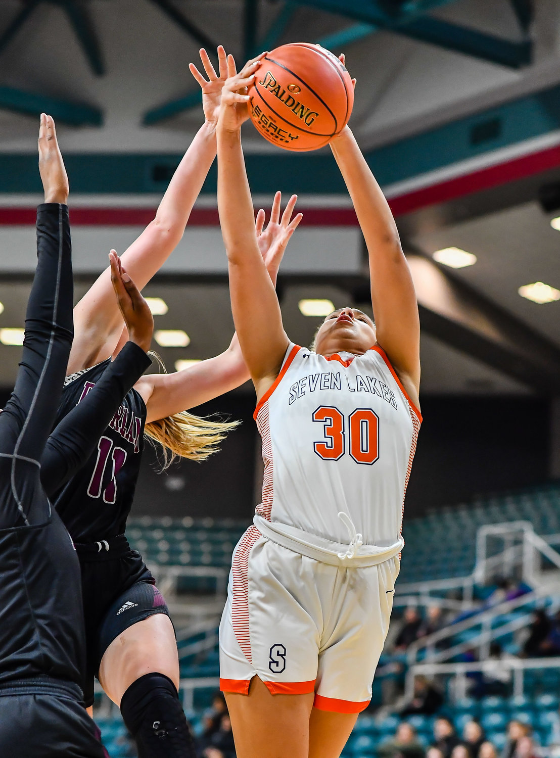 Katy Tx. Feb 25, 2022: Seven Lakes Justice Carlton #30 pulls down the rebound during the Regional SemiFinal playoff game, Seven Lakes vs Pearland at the Merrell Center. (Photo by Mark Goodman / Katy Times)
