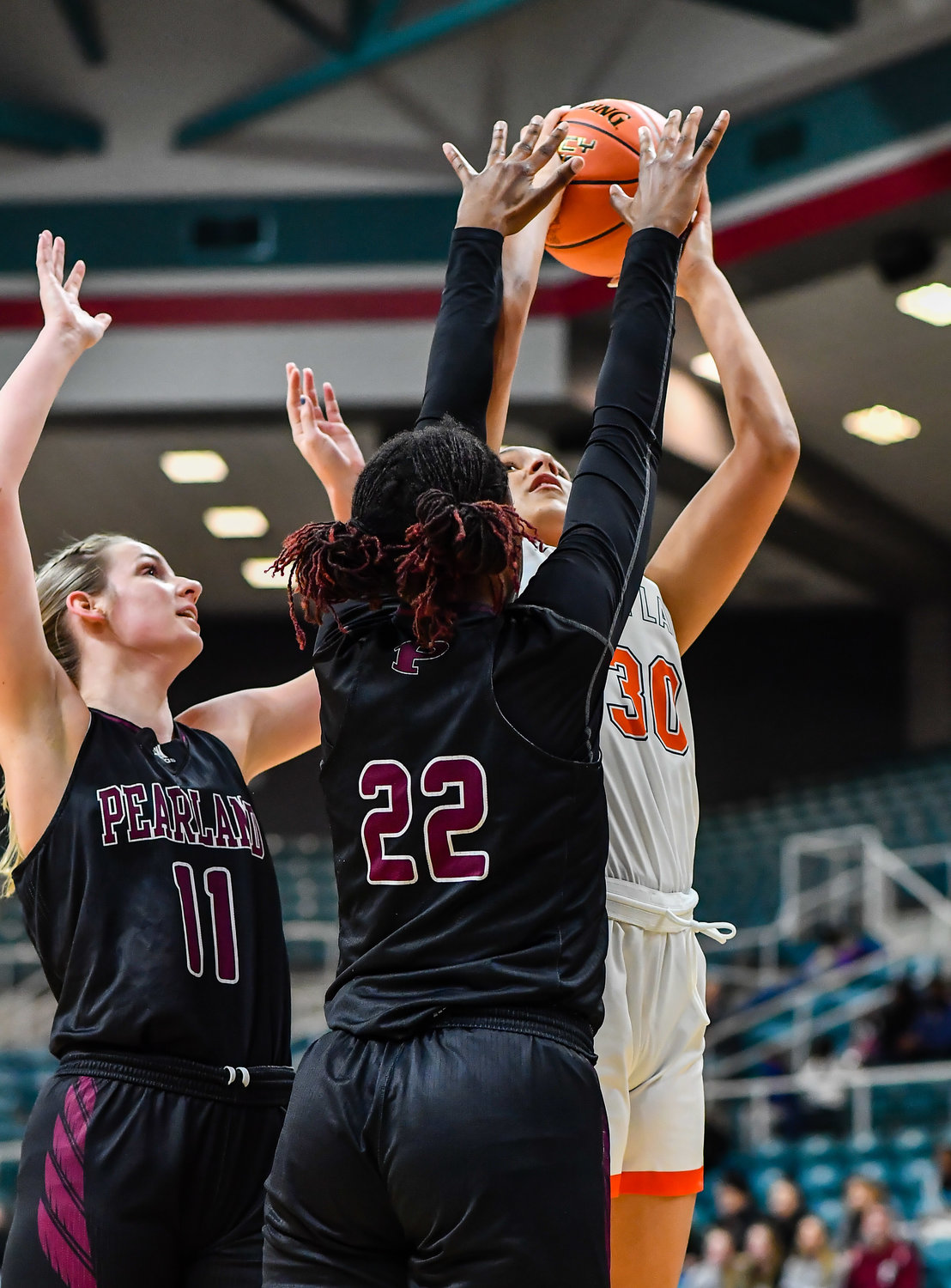 Katy Tx. Feb 25, 2022:  Seven Lakes Justice Carlton #30 goes up for the shot guarded by Pearlands Rylee Grays #22 during the Regional SemiFinal playoff game, Seven Lakes vs Pearland at the Merrell Center. (Photo by Mark Goodman / Katy Times)