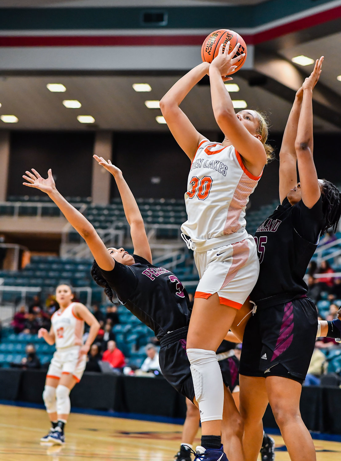 Katy Tx. Feb 25, 2022:  Seven Lakes Justice Carlton #30 goes up for the shot between two Pearland defenders during the Regional SemiFinal playoff game, Seven Lakes vs Pearland at the Merrell Center. (Photo by Mark Goodman / Katy Times)