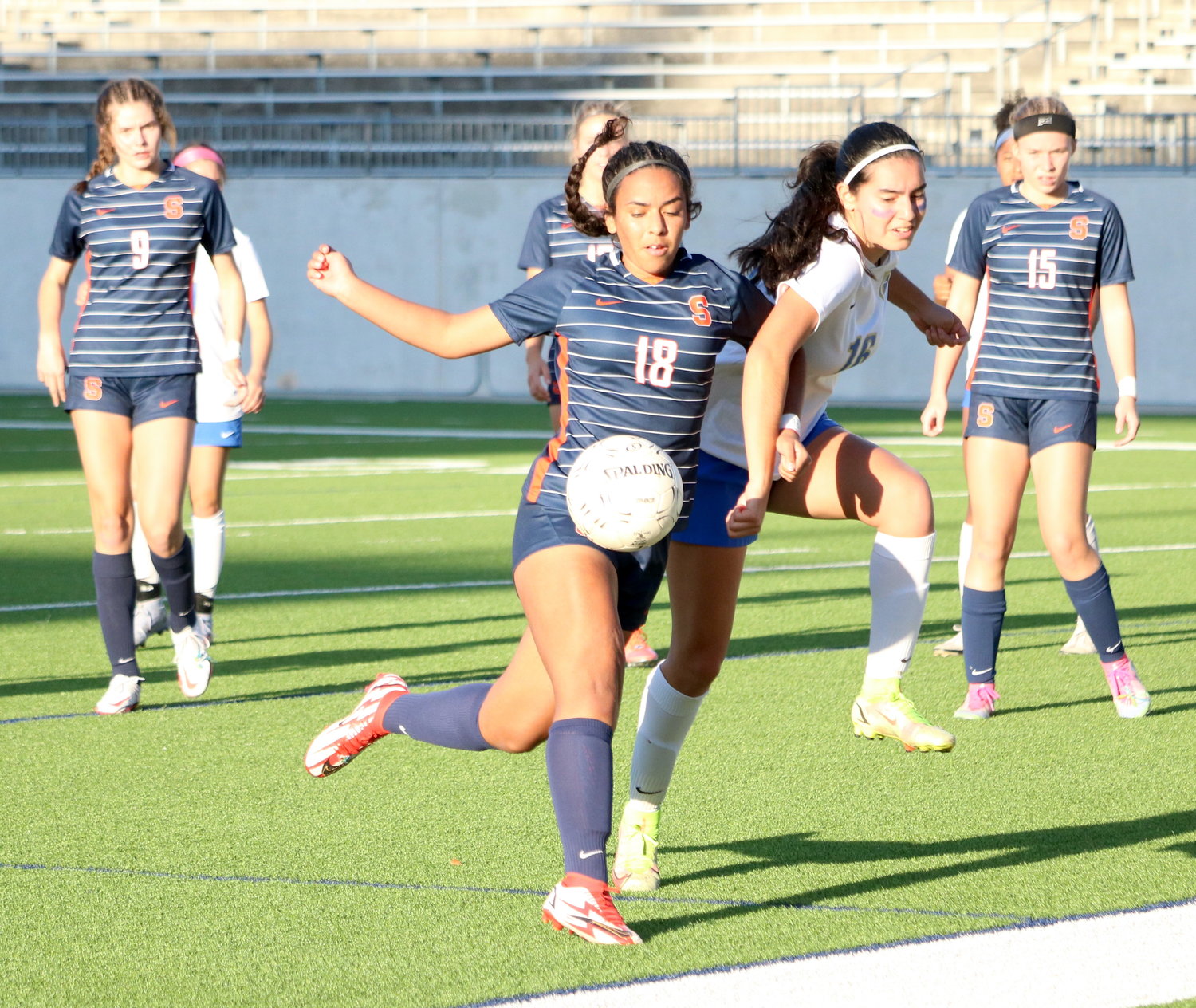 Rebecca Romero tries to hold up a ball while battling a defender during Thursday’s Class 6A bi-district round game between Seven Lakes and Fort Bend Elkins at Legacy Stadium.