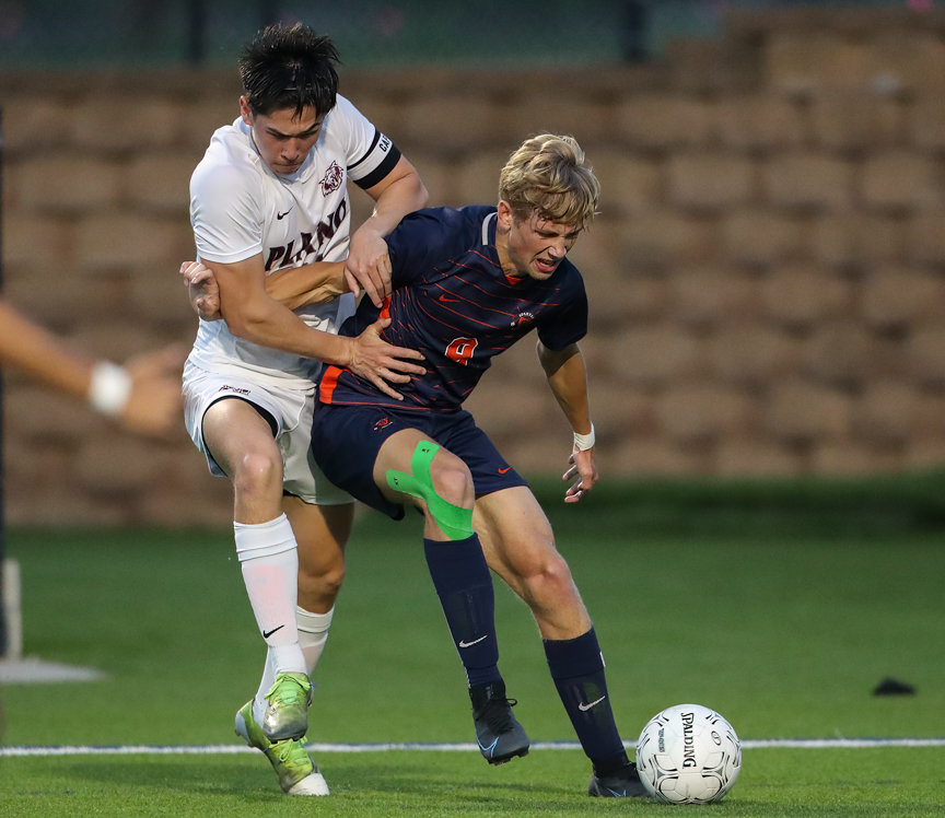 Seven Lakes forward Hunter Merritt (9) works against Plano defender Andrew Yu (11) during the Class 6A boys state semifinal between Katy Seven Lakes and Plano on April 15, 2022 in Georgetown, Texas.