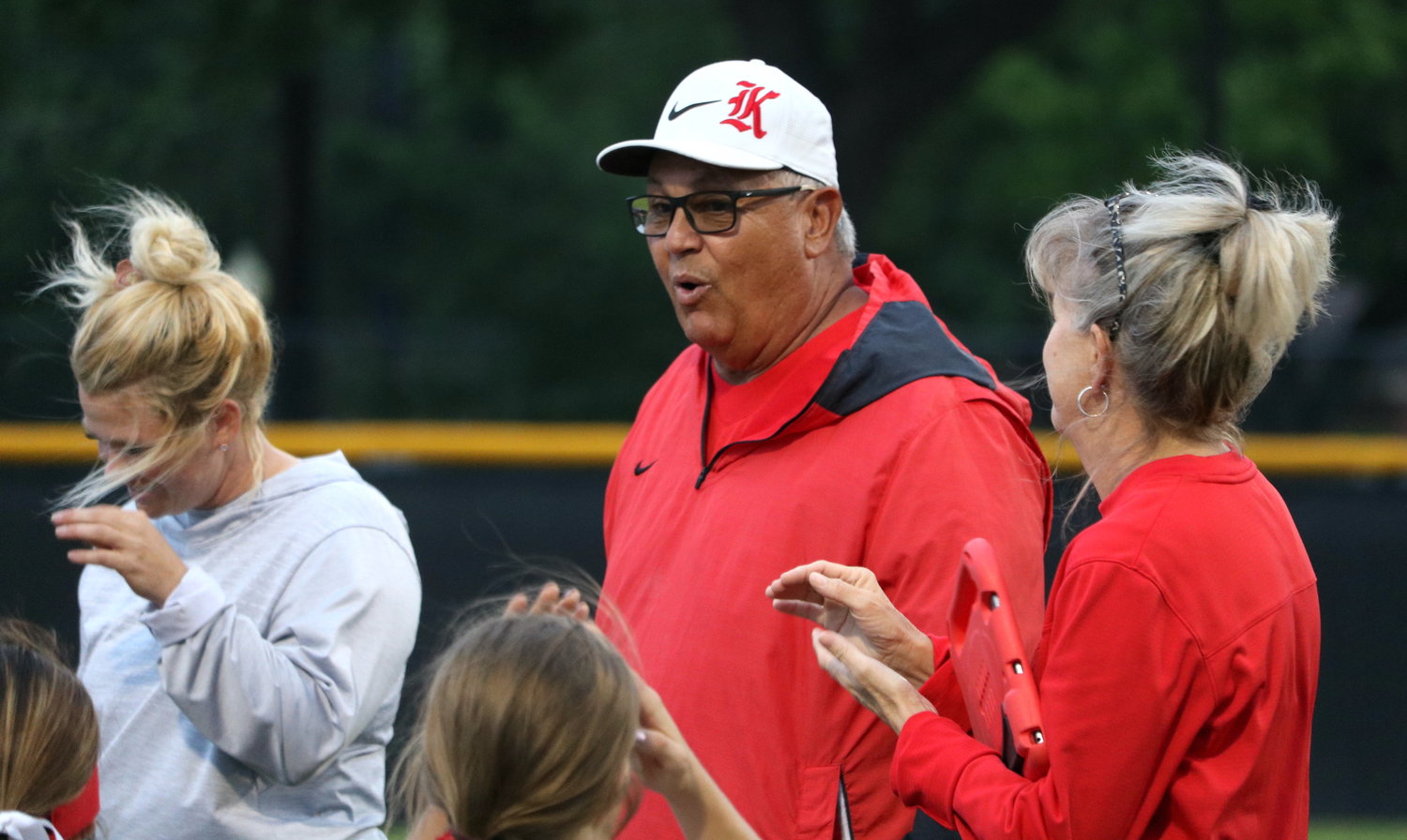 Katy head coach Kalum Haack talks to his team after the Tigers win over Taylor on Tuesday at the Katy softball field.
