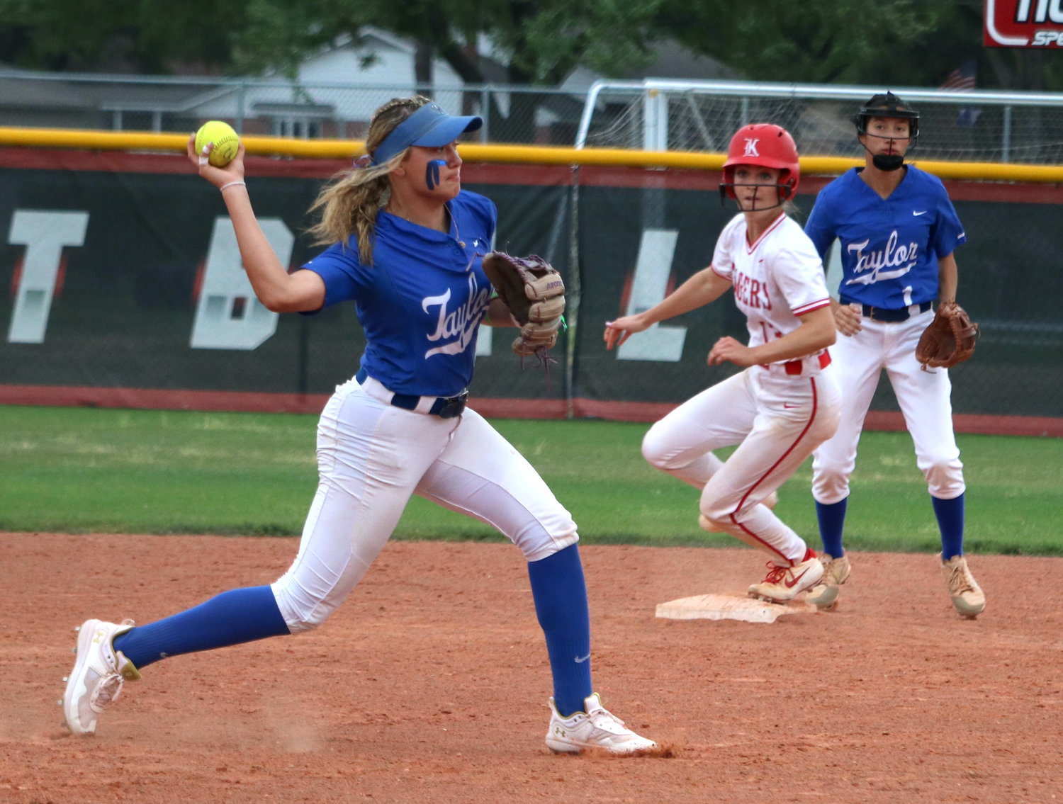Katherine Brunner throws to first base during Tuesday’s game between Katy and Taylor at the Katy softball field.